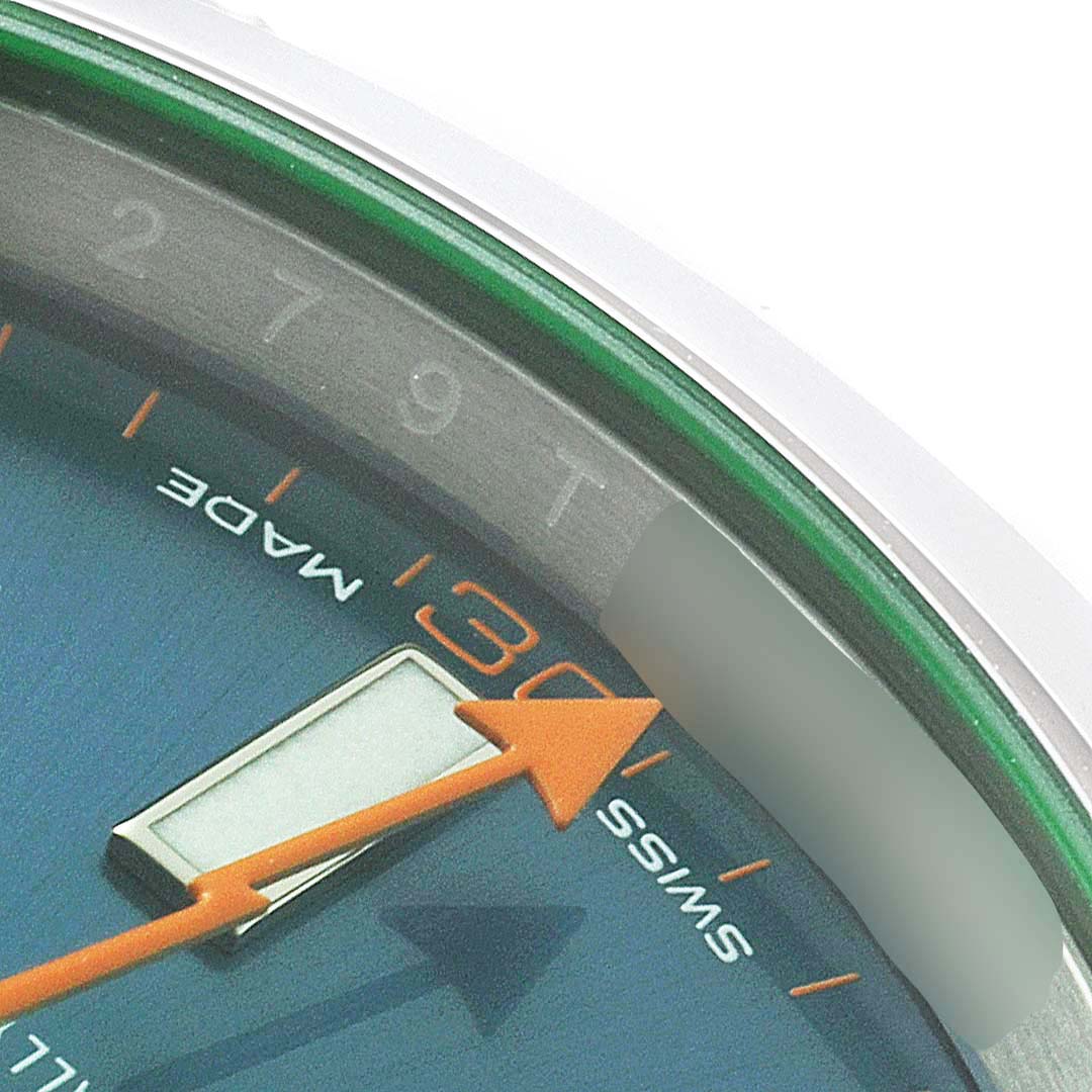 A close-up of the Rolex Milgauss 116400GV Men
s Stainless Steel Blue Dial 116400GV Men
s Stainless Steel Blue Dial watch dial showing part of the minute hand, hour markers, and portion of the bezel.