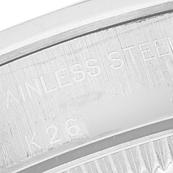 This close-up image shows the engraved text on the stainless steel back of a Rolex Oyster Perpetual 76080 Women's Stainless Steel Black Dial 76080 Women's Stainless Steel Black Dial watch.