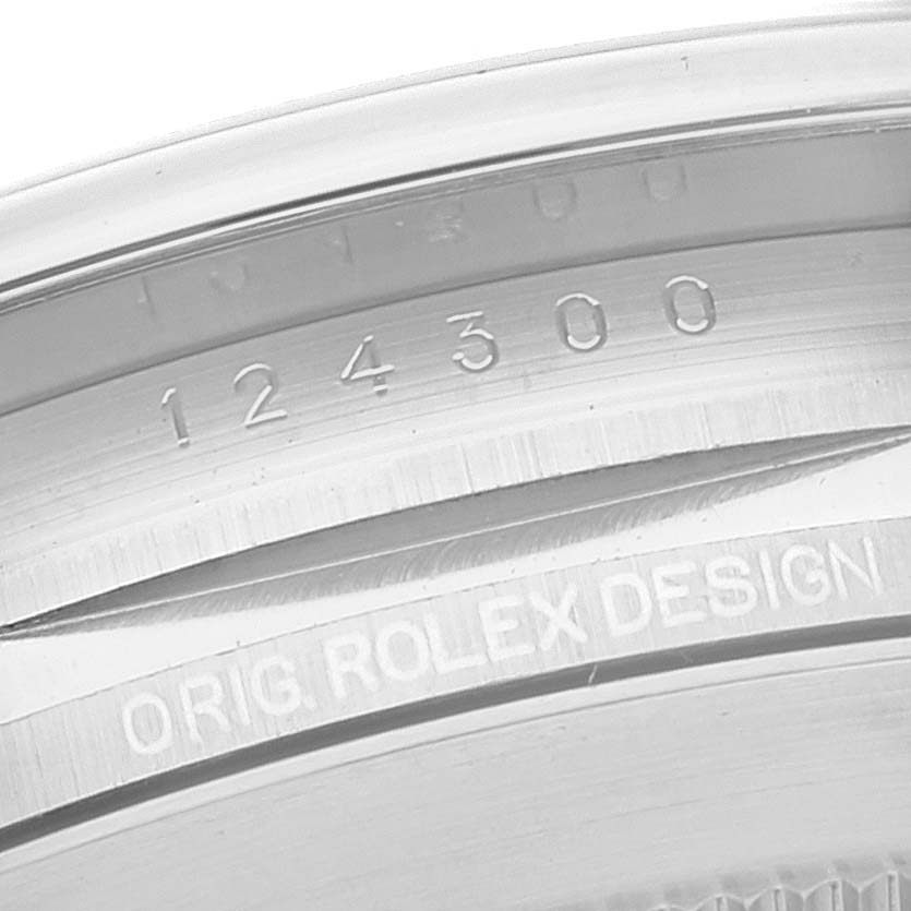 This image shows a close-up of the inner bezel of the Rolex Oyster Perpetual 124300 Men's Stainless Steel Silver Dial 124300 Men's Stainless Steel Silver Dial watch, displaying the model number "124300" and "ORIG. ROLEX DESIGN".