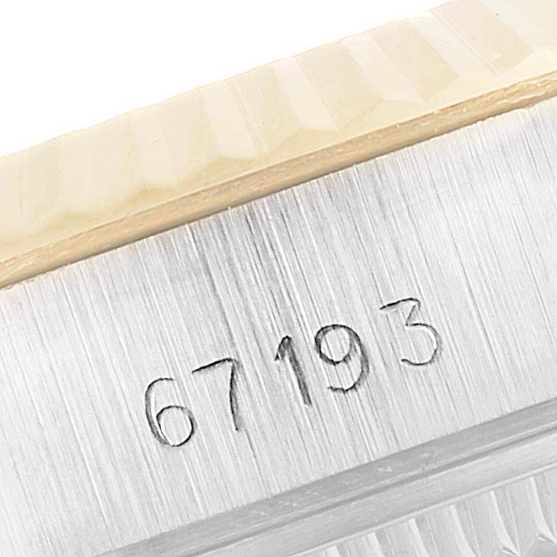 This image shows a close-up of the case side of a Rolex Oyster Perpetual 67193 Women
s Steel and Gold (two tone) Champagne Dial 67193 Women
s Steel and Gold (two tone) Champagne Dial watch with the model number 67193 engraved.