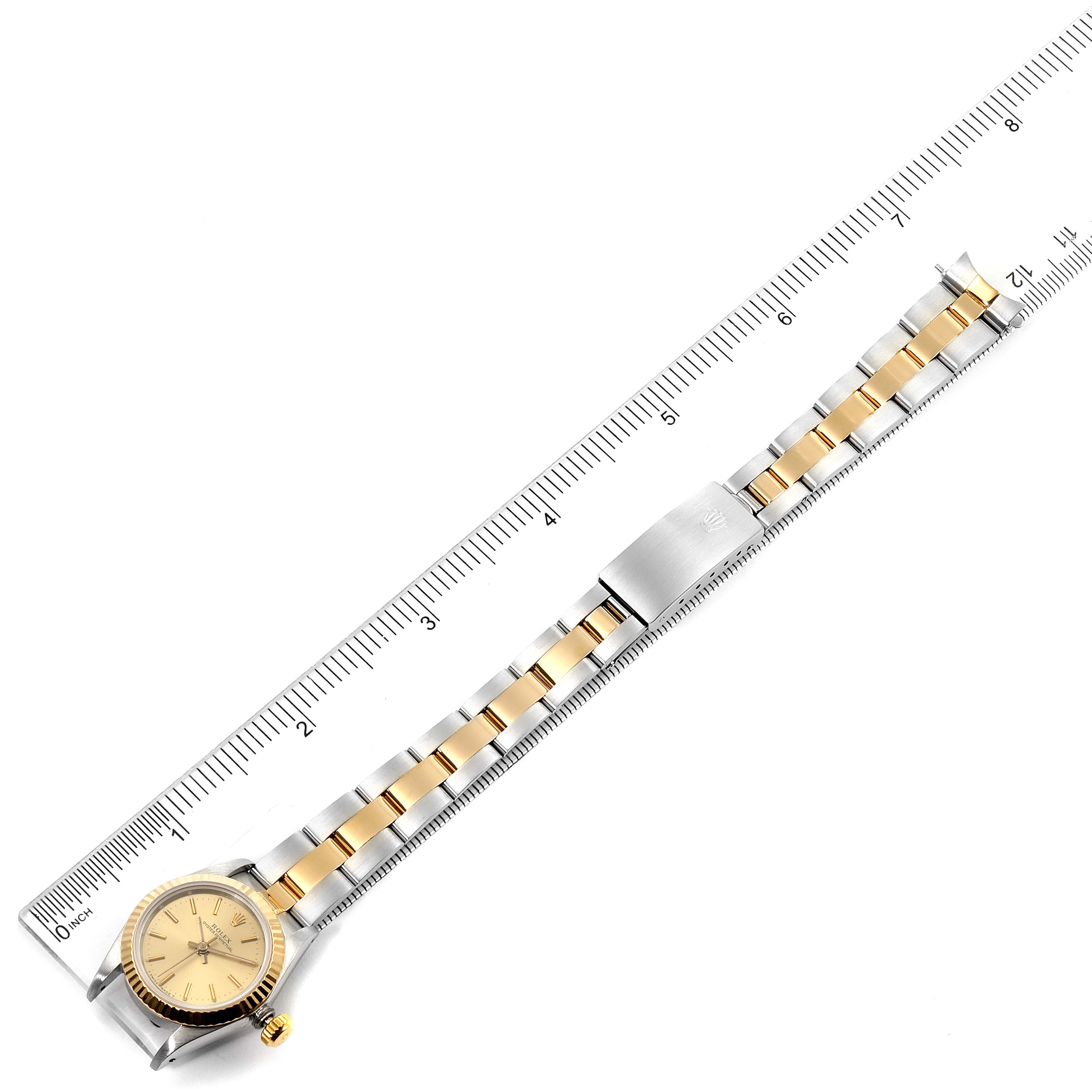 The Rolex Oyster Perpetual 67193 Women
s Steel and Gold (two tone) Champagne Dial 67193 Women
s Steel and Gold (two tone) Champagne Dial watch is shown from a top-down angle, displaying the face, bezel, and two-tone bracelet.