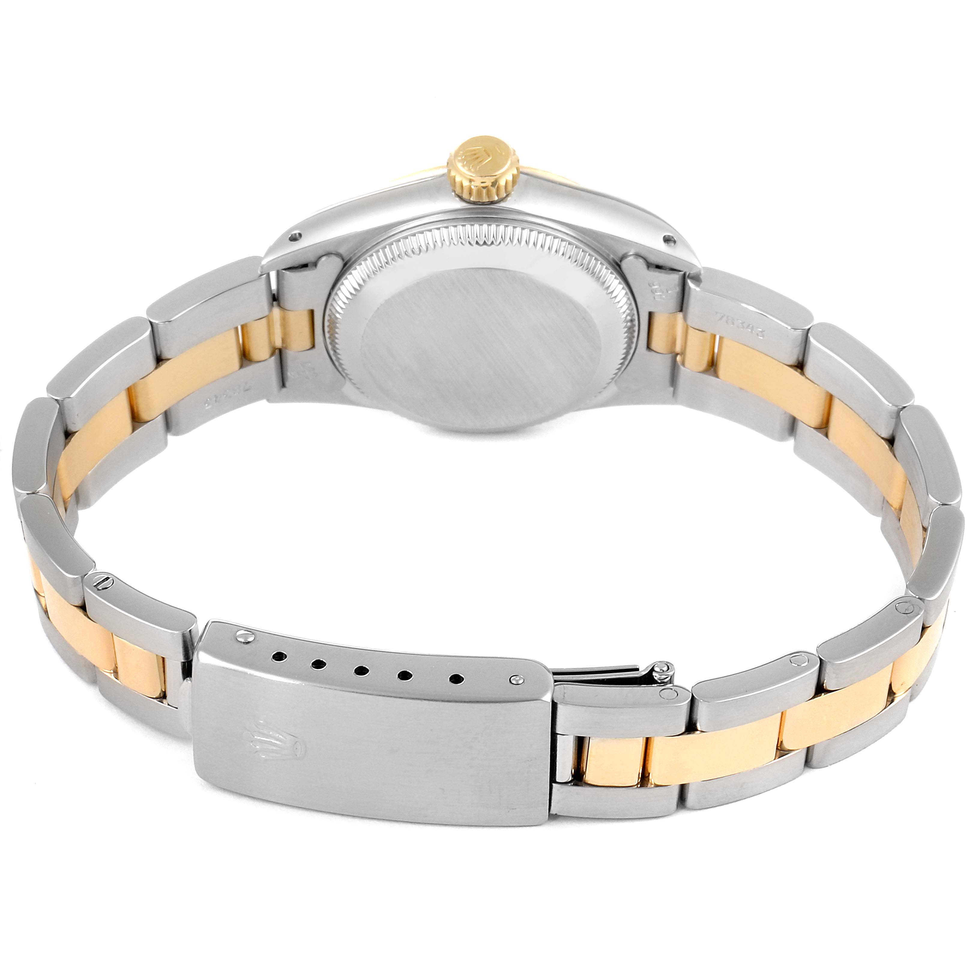 The image shows the back view of a Rolex Oyster Perpetual 67193 Women
s Steel and Gold (two tone) Champagne Dial 67193 Women
s Steel and Gold (two tone) Champagne Dial watch, highlighting its case back, crown, and metal bracelet.