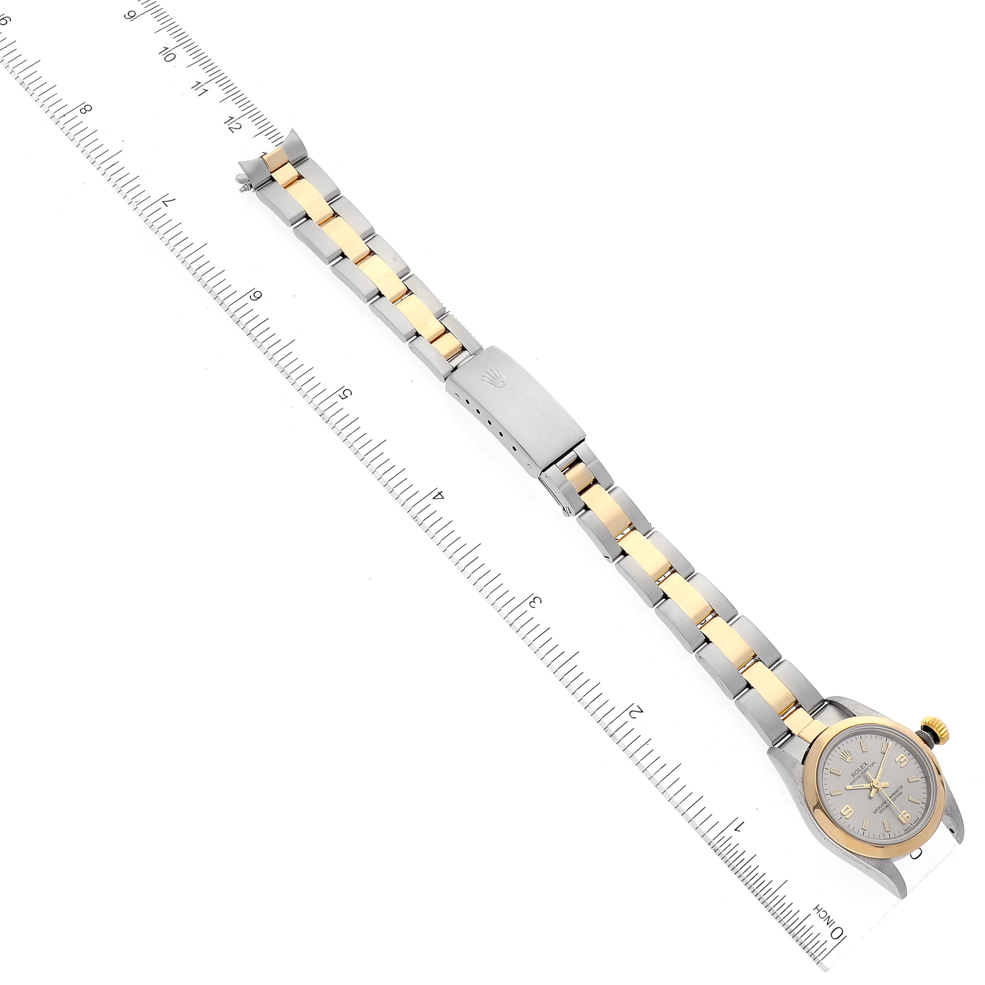 The Rolex Oyster Perpetual 67183 Women's Steel and Gold (two tone) Silver Dial 67183 Women's Steel and Gold (two tone) Silver Dial watch is shown at a top-down angle, highlighting its bracelet, clasp, and dial.