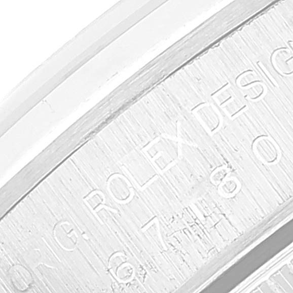 The image shows an angled close-up of the inner bezel with engravings on a Rolex Oyster Perpetual 67180 Women's Stainless Steel Blue Dial 67180 Women's Stainless Steel Blue Dial watch.