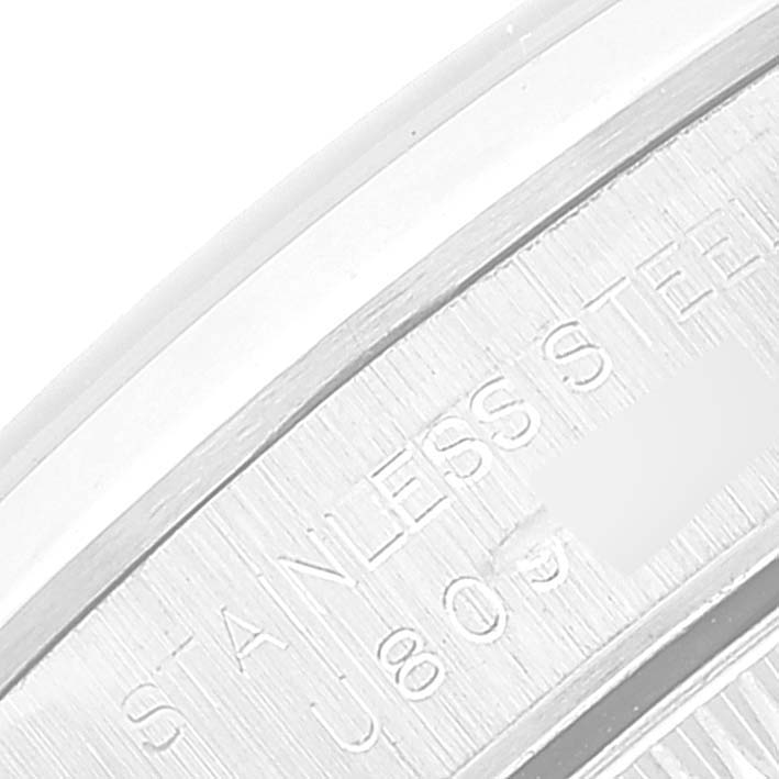 This image shows a close-up of the case back engraving of a Rolex Oyster Perpetual 67180 Women's Stainless Steel Blue Dial 67180 Women's Stainless Steel Blue Dial watch, indicating its stainless steel composition.