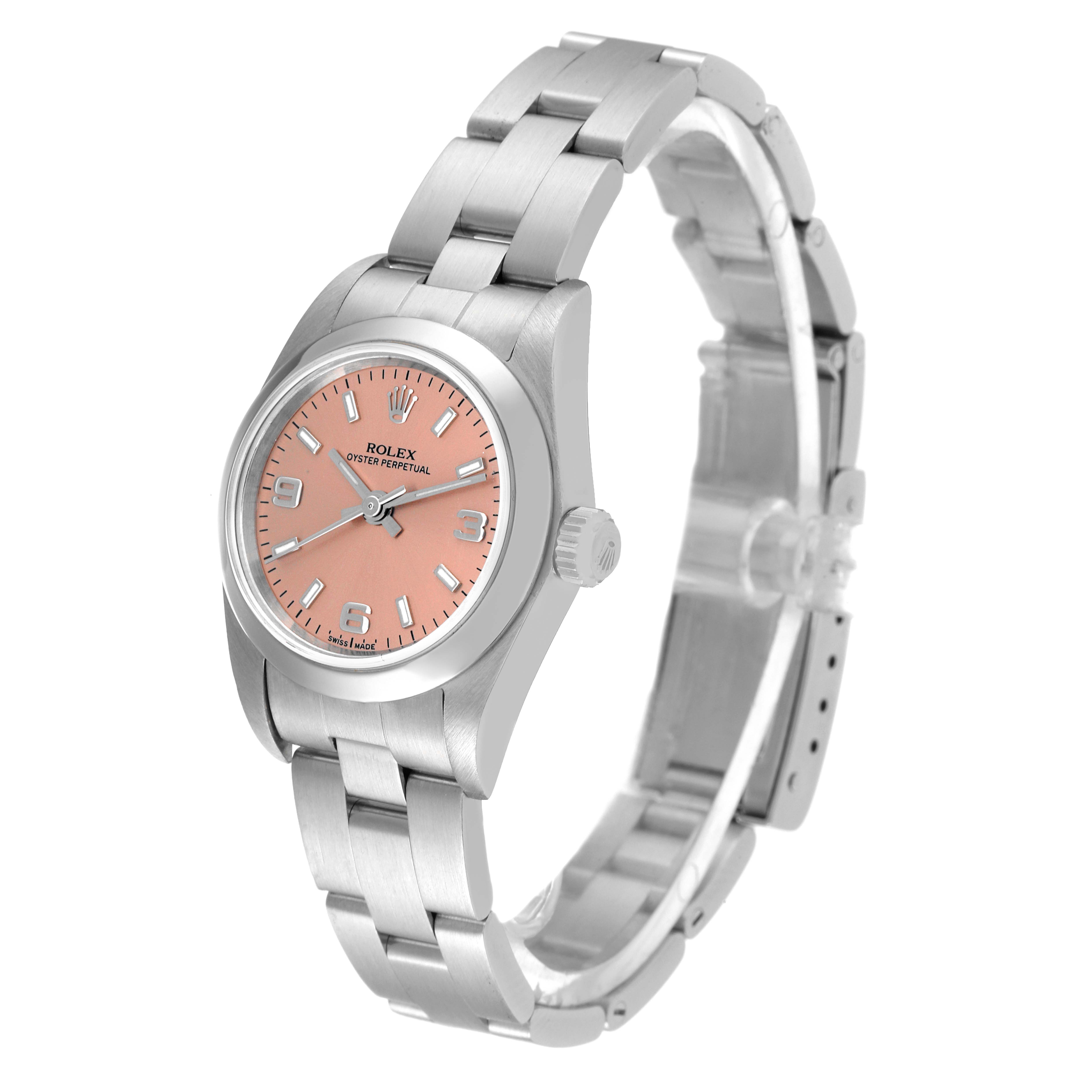 This image shows an angled view of a Rolex Oyster Perpetual 76080 Women
s Stainless Steel Pink Dial 76080 Women
s Stainless Steel Pink Dial watch featuring its bracelet, pink dial, and crown.