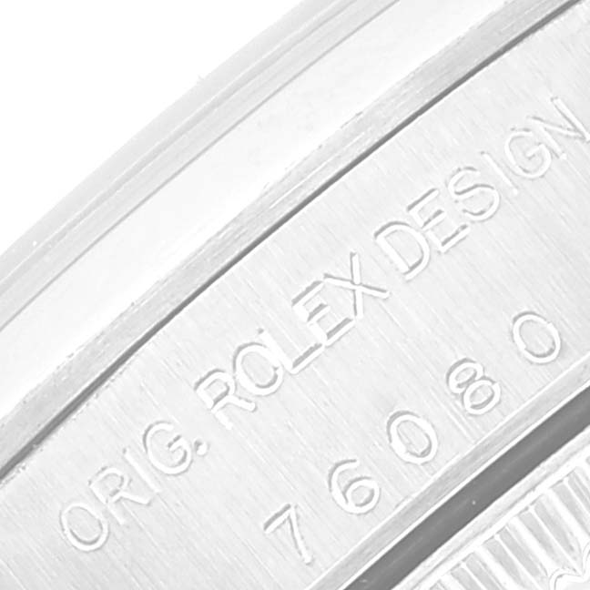 The image shows a close-up of the engraved case back and serial number of a Rolex Oyster Perpetual 76080 Women
s Stainless Steel Pink Dial 76080 Women
s Stainless Steel Pink Dial watch.