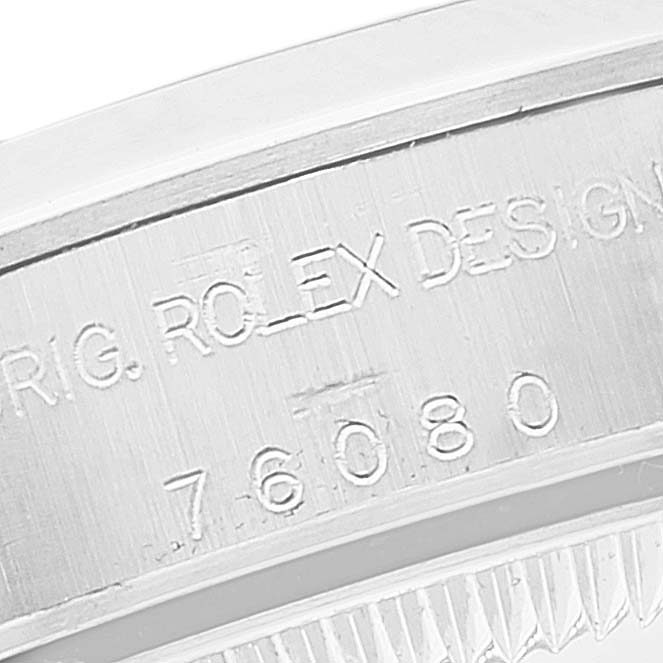 This close-up image shows the engraved details on the bezel of a Rolex Oyster Perpetual 76080 Women's Stainless Steel White Dial 76080 Women's Stainless Steel White Dial watch, emphasizing its model number.