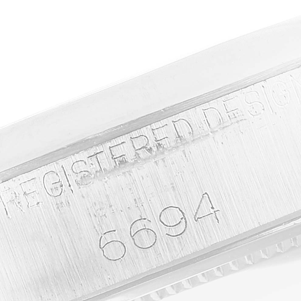 The image shows the side of the Vintage Collection model by Rolex, highlighting the "REGISTERED DESIGN" and model number "6694".