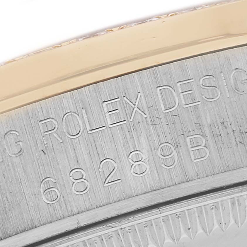 The image shows a close-up of the engraved edge of a Rolex President 68289 Women's White Gold Silver Dial 68289 Women's White Gold Silver Dial model watch case.