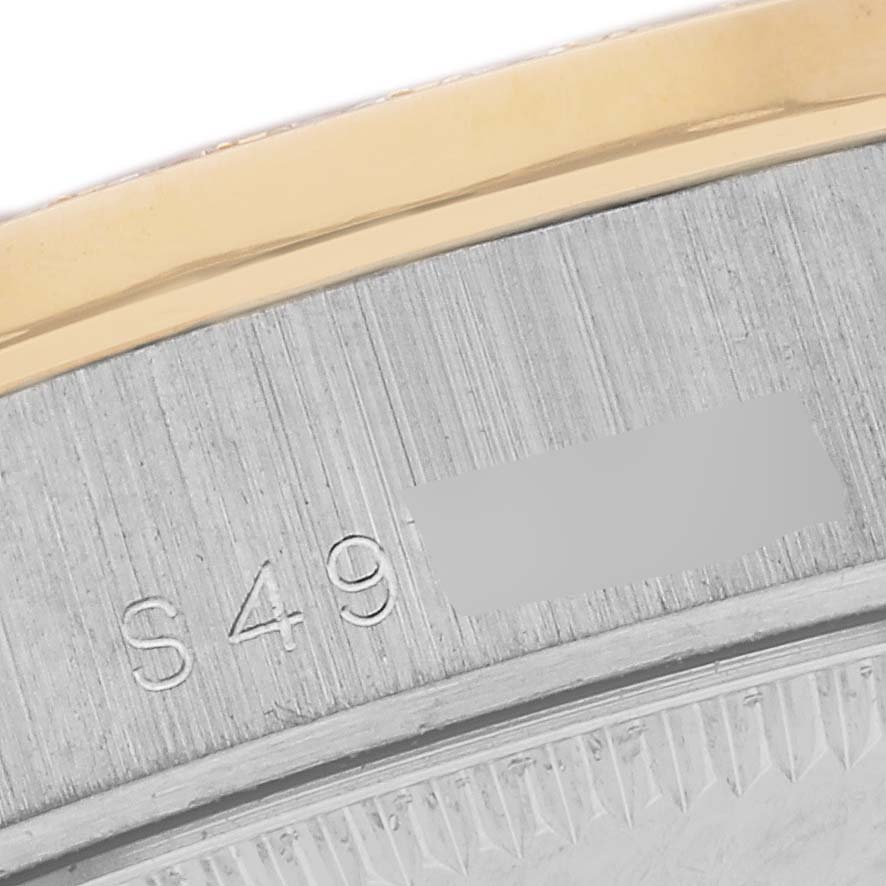 The image shows a close-up of the Rolex President 68289 Women's White Gold Silver Dial 68289 Women's White Gold Silver Dial watch case edge, featuring engraved numbers and a gold bezel.