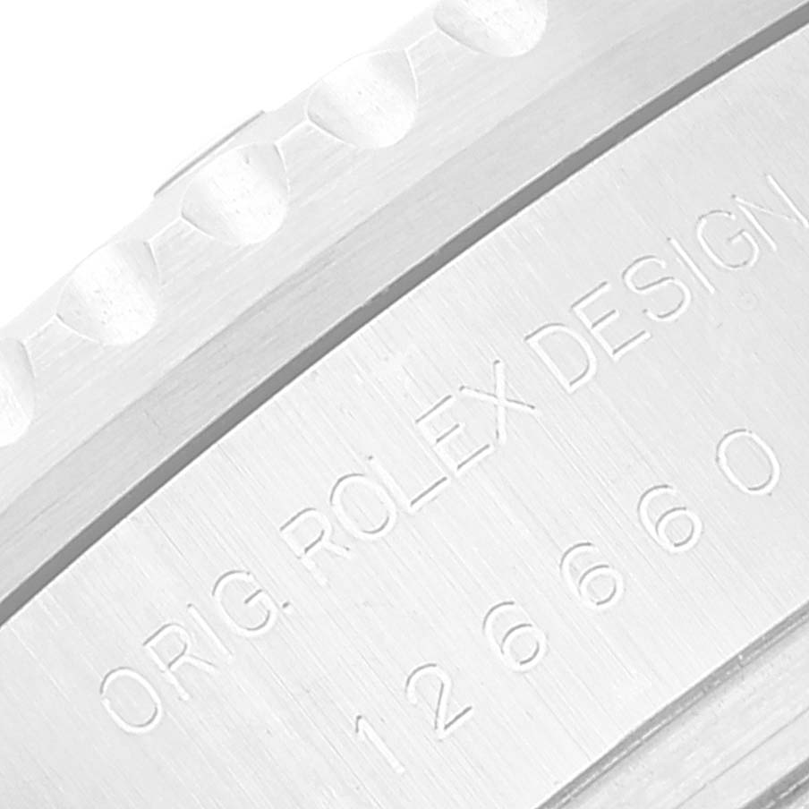 This image shows a close-up of the engraved text on the side of the bezel of a Rolex Sea-Dweller 126660 Men's Stainless Steel Blue Dial 126660 Men's Stainless Steel Blue Dial watch.