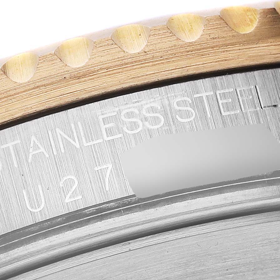 This close-up image shows a portion of the bezel and the engraved stainless steel casing of a Rolex Submariner 16613 Men
s Steel and Gold (two tone) Blue Dial 16613 Men
s Steel and Gold (two tone) Blue Dial watch.