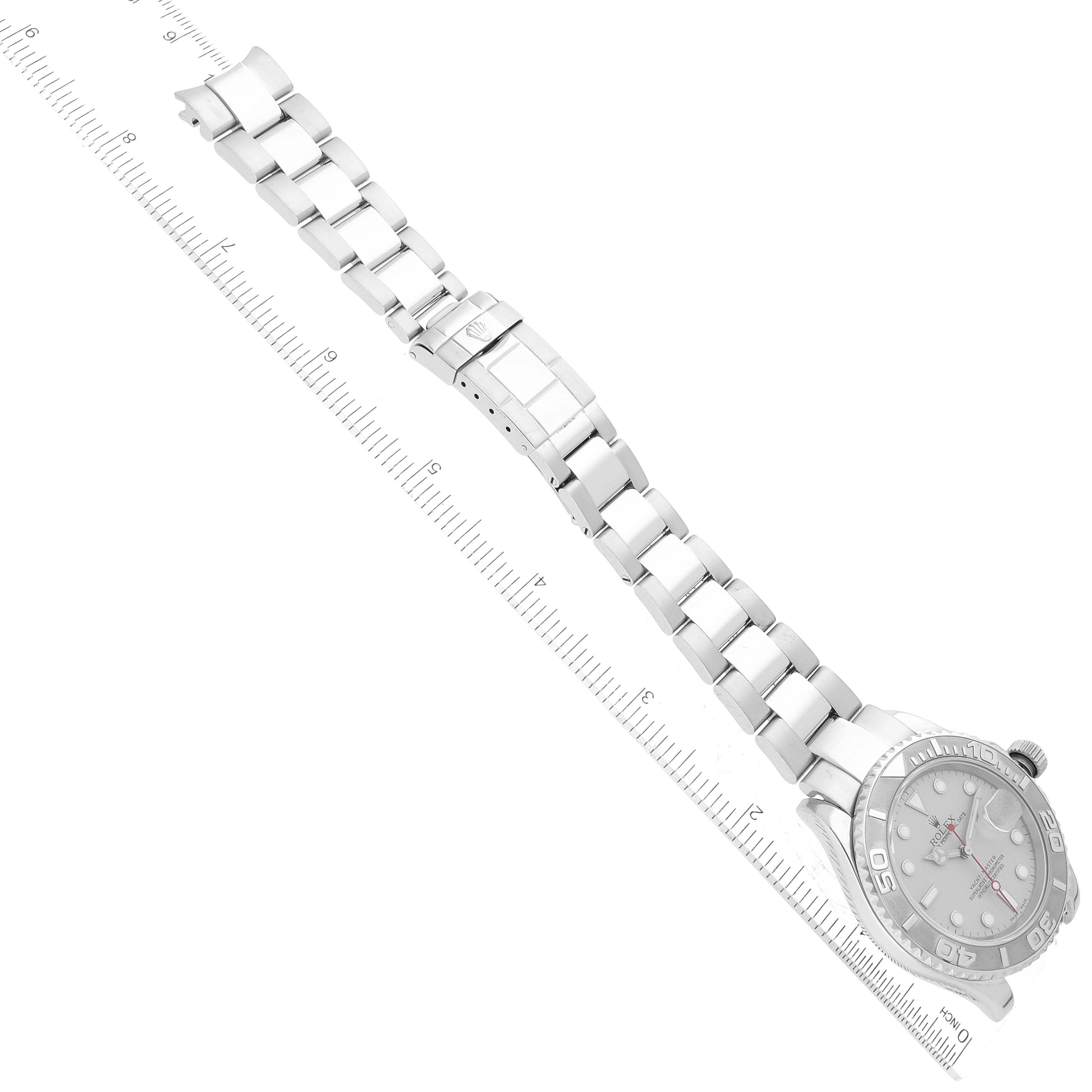 The Rolex Yacht-Master 16622 Men's Stainless Steel Silver Dial 16622 Men's Stainless Steel Silver Dial watch is shown laid flat with its face and bracelet fully visible, alongside a measuring ruler.