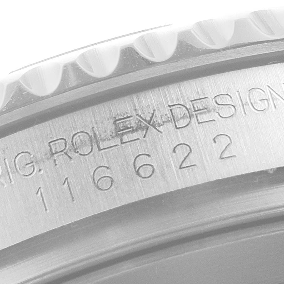 The image shows a close-up of the Rolex Yacht-Master 116622 Men's Stainless Steel Grey Dial 116622 Men's Stainless Steel Grey Dial model's case, featuring the bezel edge and engraved serial number.