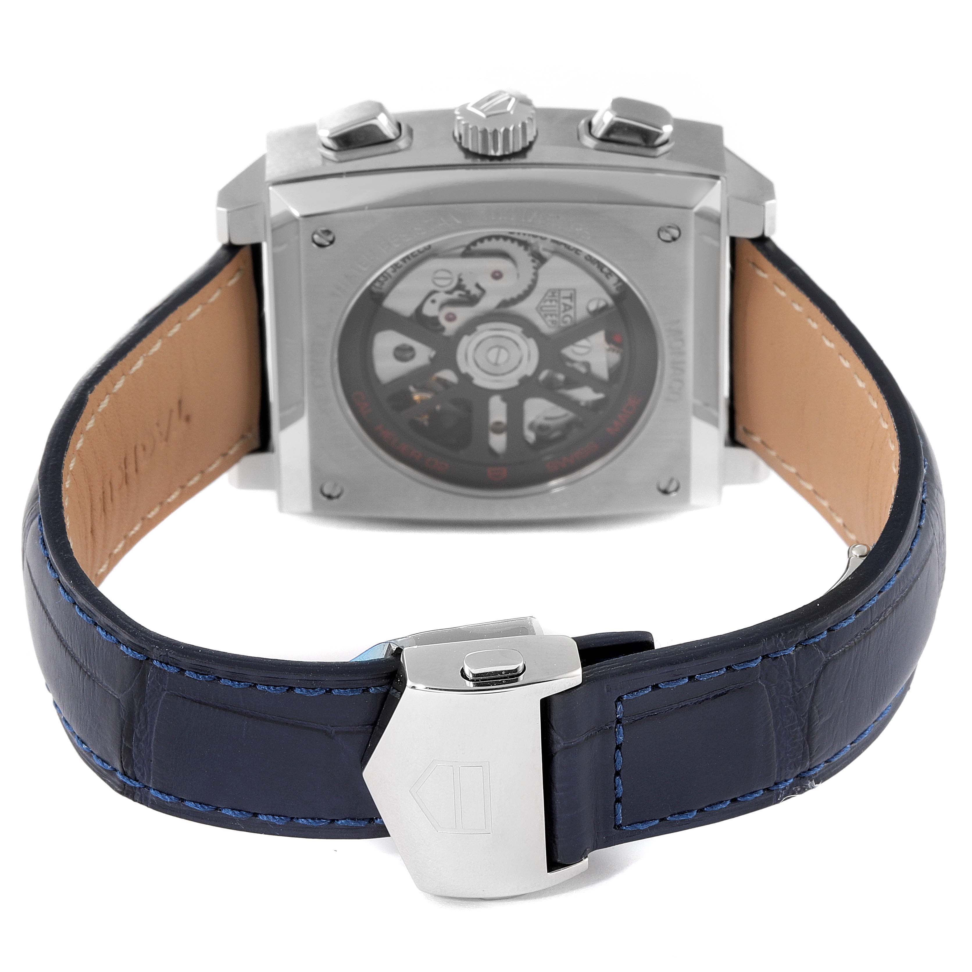 The image shows the back view of a Tag Heuer Monaco CBL2111.FC6453 Men's Stainless Steel Blue Dial CBL2111.FC6453 Men's Stainless Steel Blue Dial watch, showcasing its transparent case back and blue leather strap with a clasp.