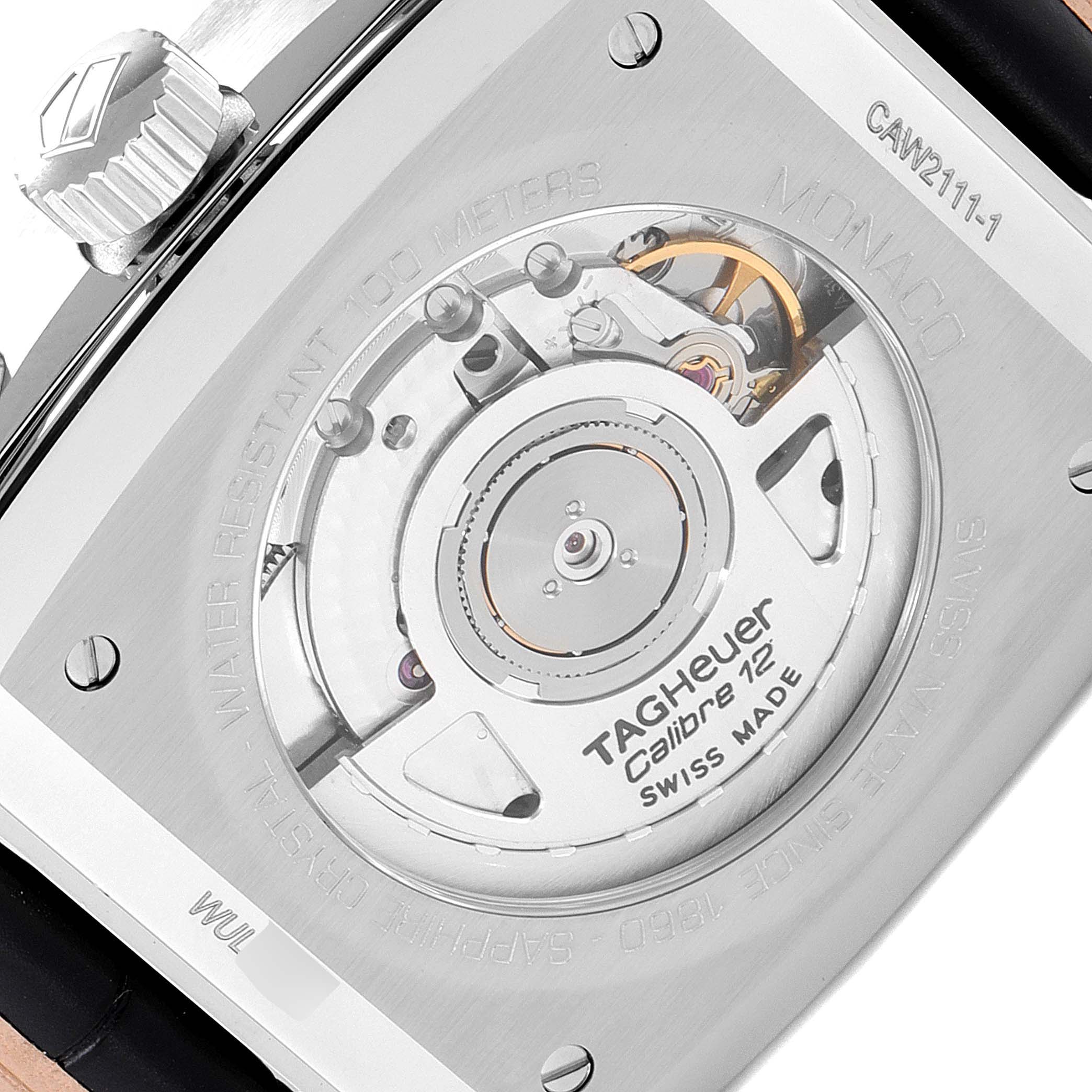 This image shows the back of the Tag Heuer Monaco CAW2111 Men's Stainless Steel Blue Dial CAW2111 Men's Stainless Steel Blue Dial watch, revealing its mechanical movement and the "Calibre 12" engraving.