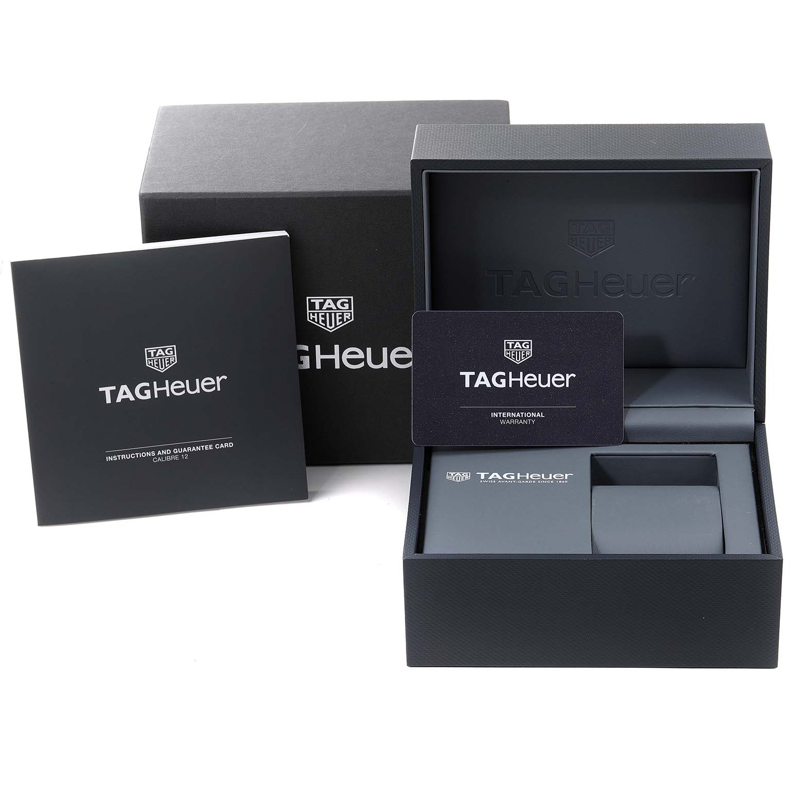 The image shows the packaging and accessories for the Tag Heuer Monaco CAW2111 Men's Stainless Steel Blue Dial CAW2111 Men's Stainless Steel Blue Dial watch, including the box, warranty card, and instructions.