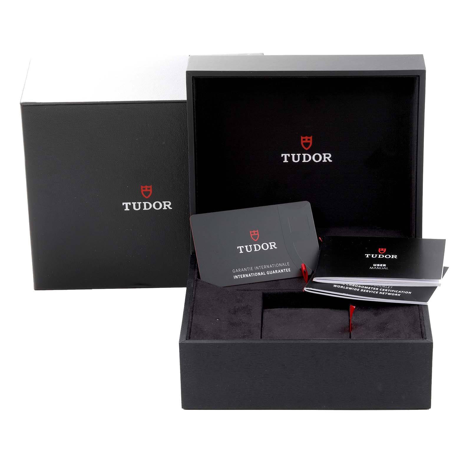 This image shows the open box of a Tudor Heritage Black Bay M79470 Men
s Stainless Steel Black Dial M79470 Men
s Stainless Steel Black Dial watch, including the guarantee card and user manual.