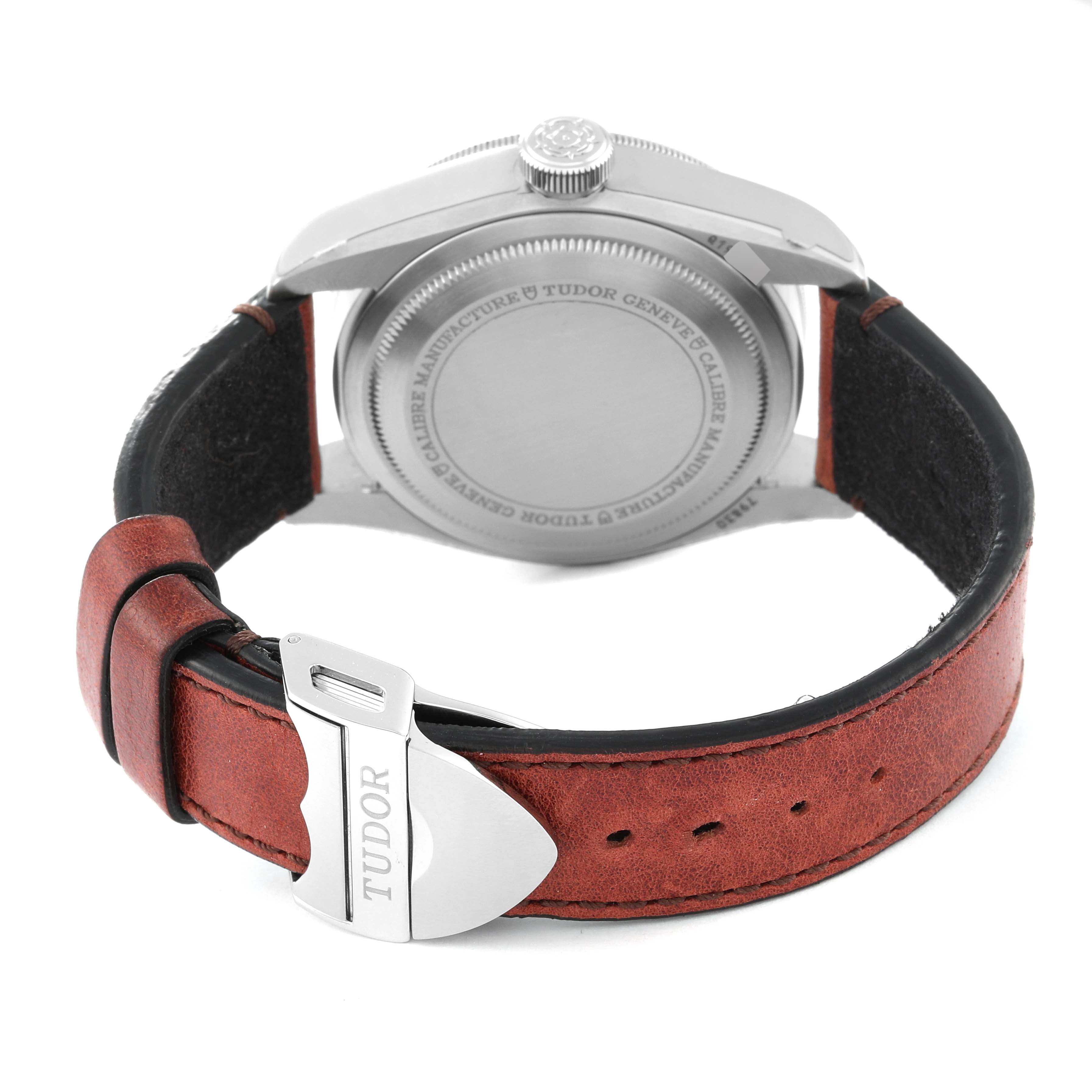 This image shows the Heritage Black Bay by Tudor from the rear angle, focusing on the case back and leather strap with the branded clasp.