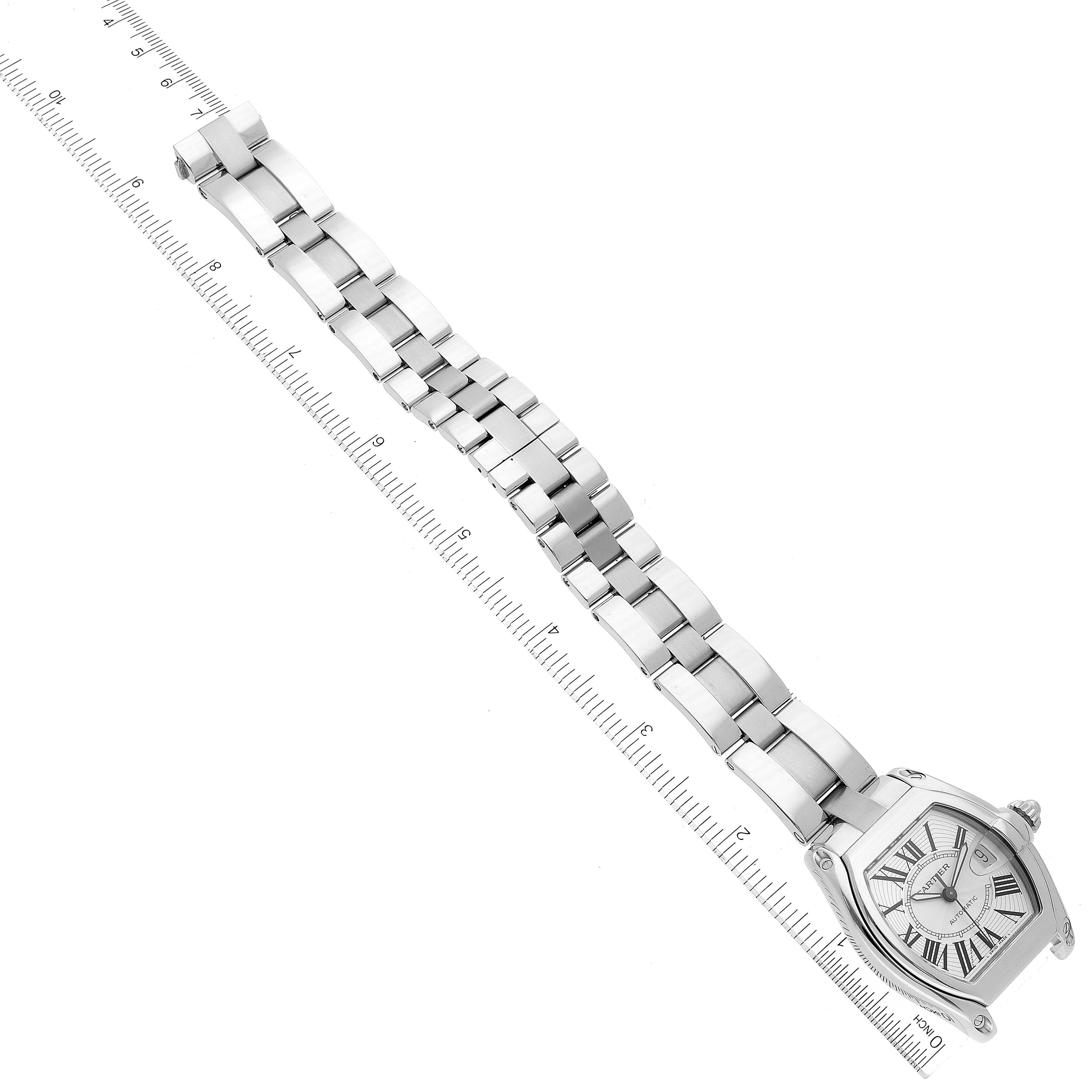 The image shows a top-down view of a Cartier Roadster W62025V3 Men's Stainless Steel Silver Dial W62025V3 Men's Stainless Steel Silver Dial watch with a metal bracelet, placed alongside a ruler for scale.