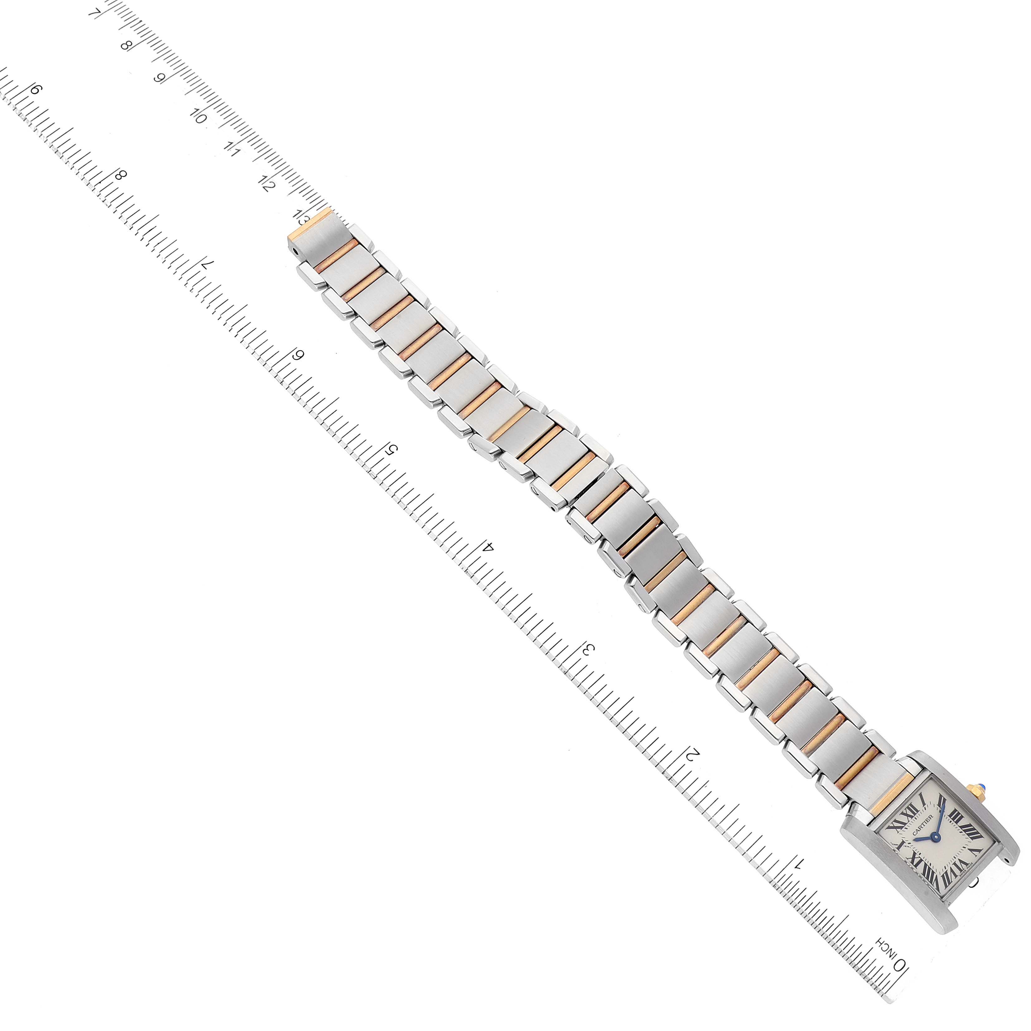 This image shows the Cartier Tank Francaise W51007Q4 Women's Steel and Gold (two tone) Silver Dial W51007Q4 Women's Steel and Gold (two tone) Silver Dial watch from an overhead angle, displaying the entire band and face next to a ruler.