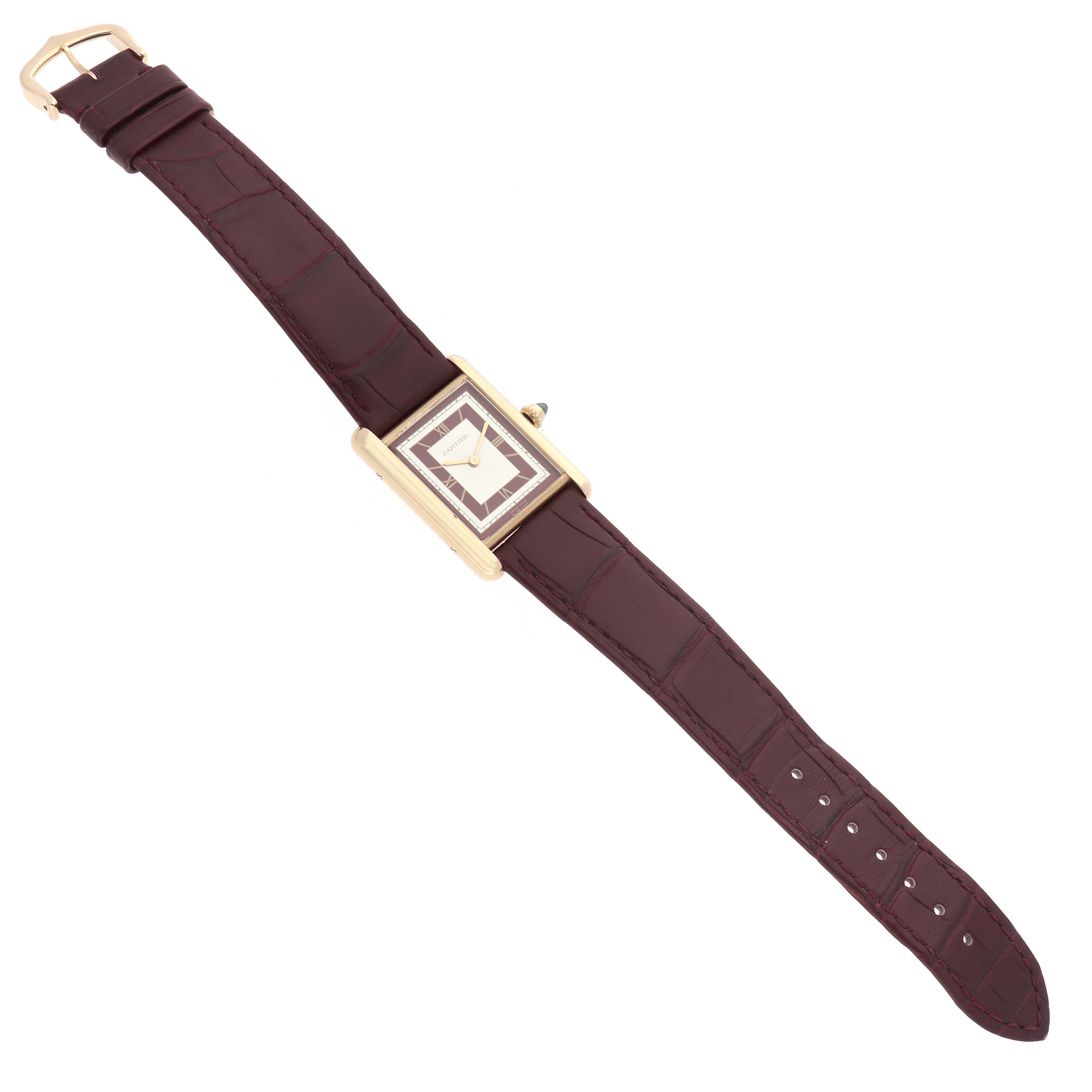 The Cartier Tank Louis WGTA0190 Men's Yellow Gold Burgundy Dial watch is shown from a top-down angle, highlighting its rectangular case, crown, and full leather strap.
