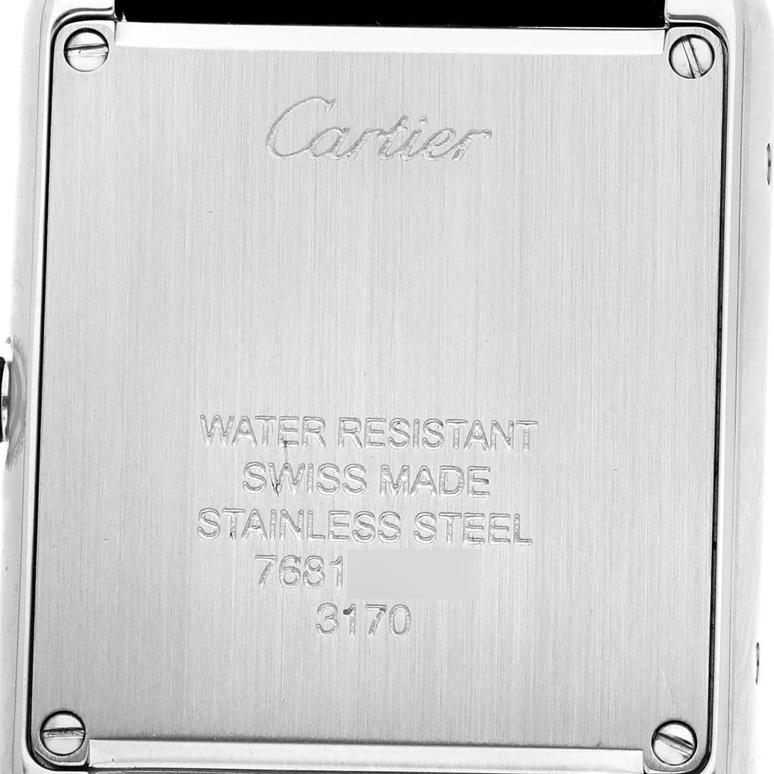The image shows the back case of a Cartier Tank Solo W5200005 Women's Stainless Steel Silver Dial watch with engraved details.