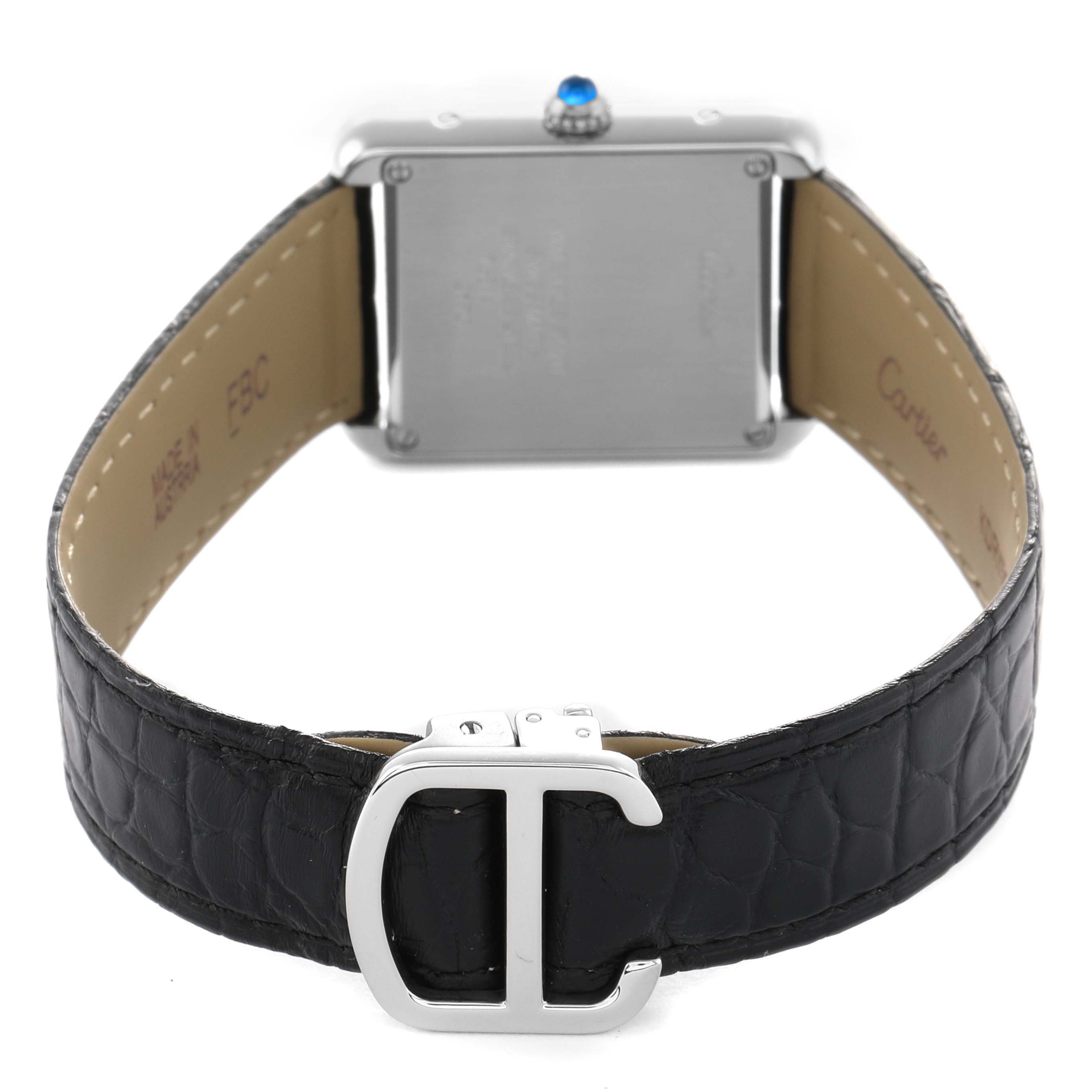 The image shows the back of a Cartier Tank Solo W5200005 Women's Stainless Steel Silver Dial watch, highlighting the case, blue cabochon crown, and black leather strap with a clasp.