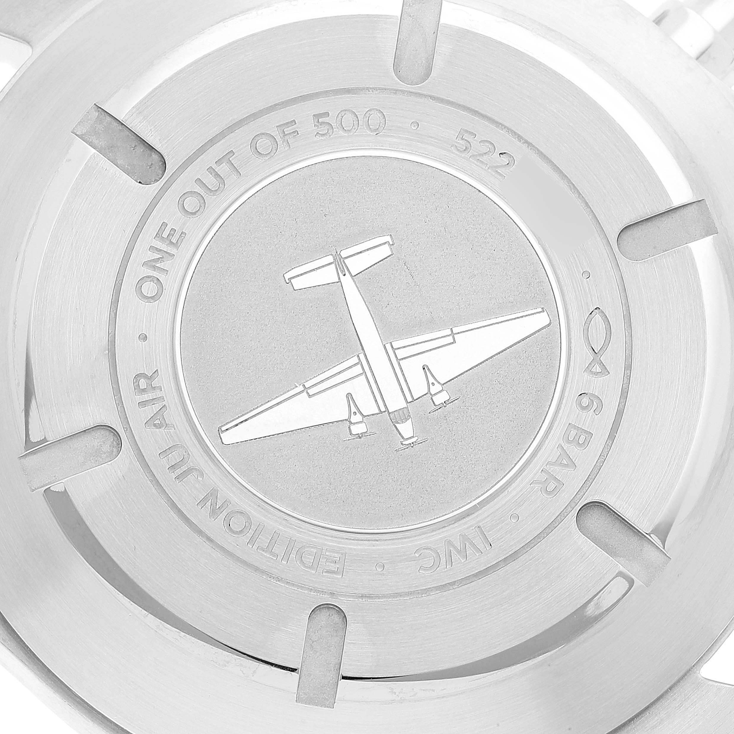 The image shows the back case of an IWC Pilot IW387809 Men's Stainless Steel Silver Dial IW387809 Men's Stainless Steel Silver Dial model watch, featuring an airplane engraving and various inscriptions.