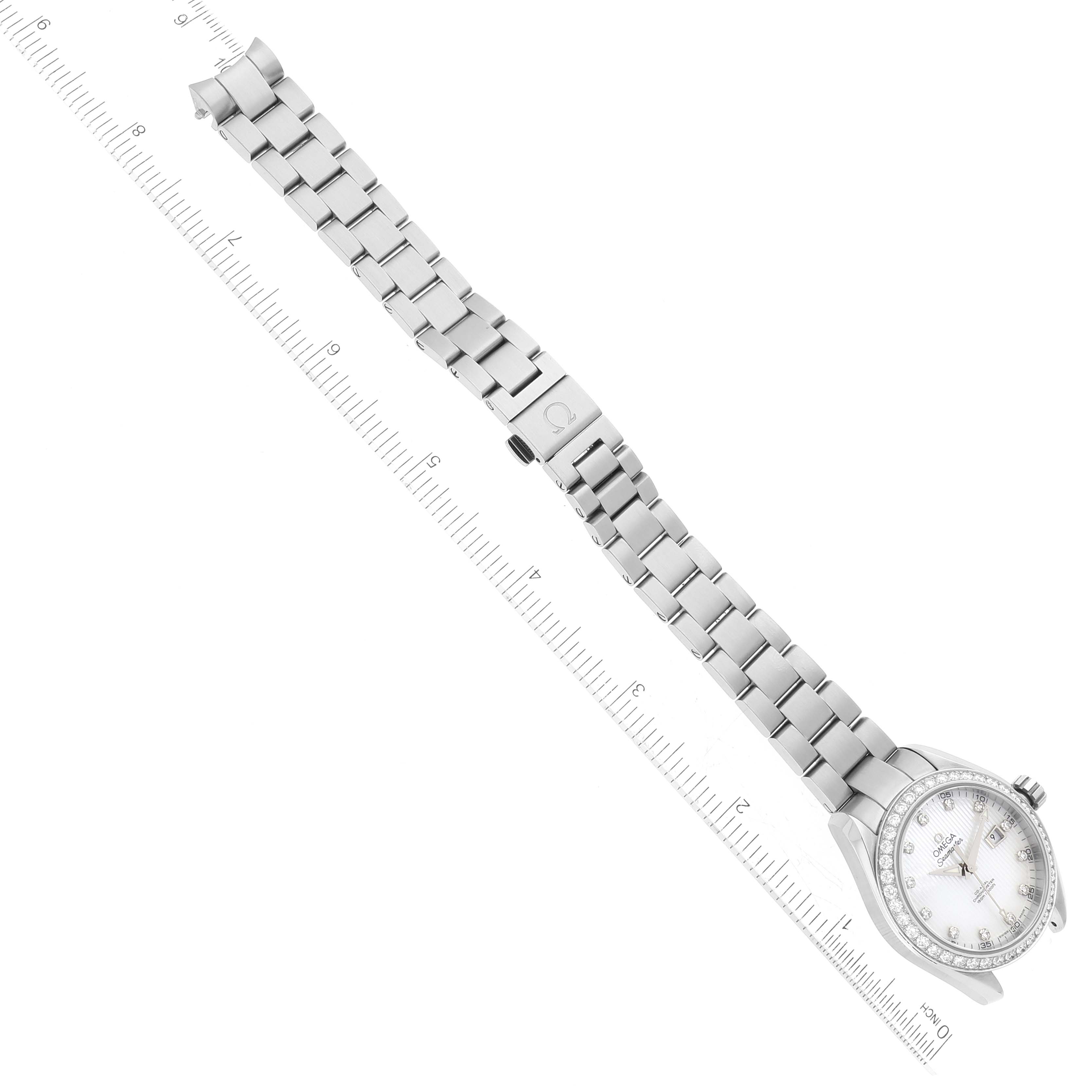 The image shows an overhead view of the Omega 231.15.34.20.55.001 Women's Stainless Steel Mother of Pearl Dial 231.15.34.20.55.001 Women's Stainless Steel Mother of Pearl Dial Aqua Terra Mother of Pearl Steel Diamond Ladies Watch 231.15.34.20.55.001 with a ruler.