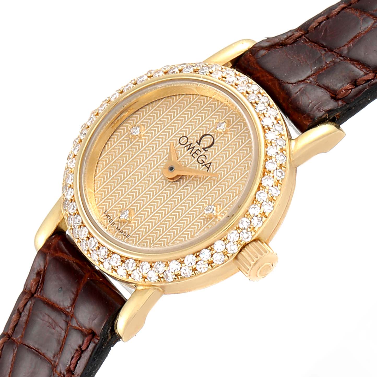 The image shows an Omega 1450 Women's Yellow Gold Champagne Dial 1450 Women's Yellow Gold Champagne Dial DeVille Mini Yellow Gold Diamond Cocktail Ladies Watch 1450 from an angle, highlighting its dial, bezel, crown, and strap.