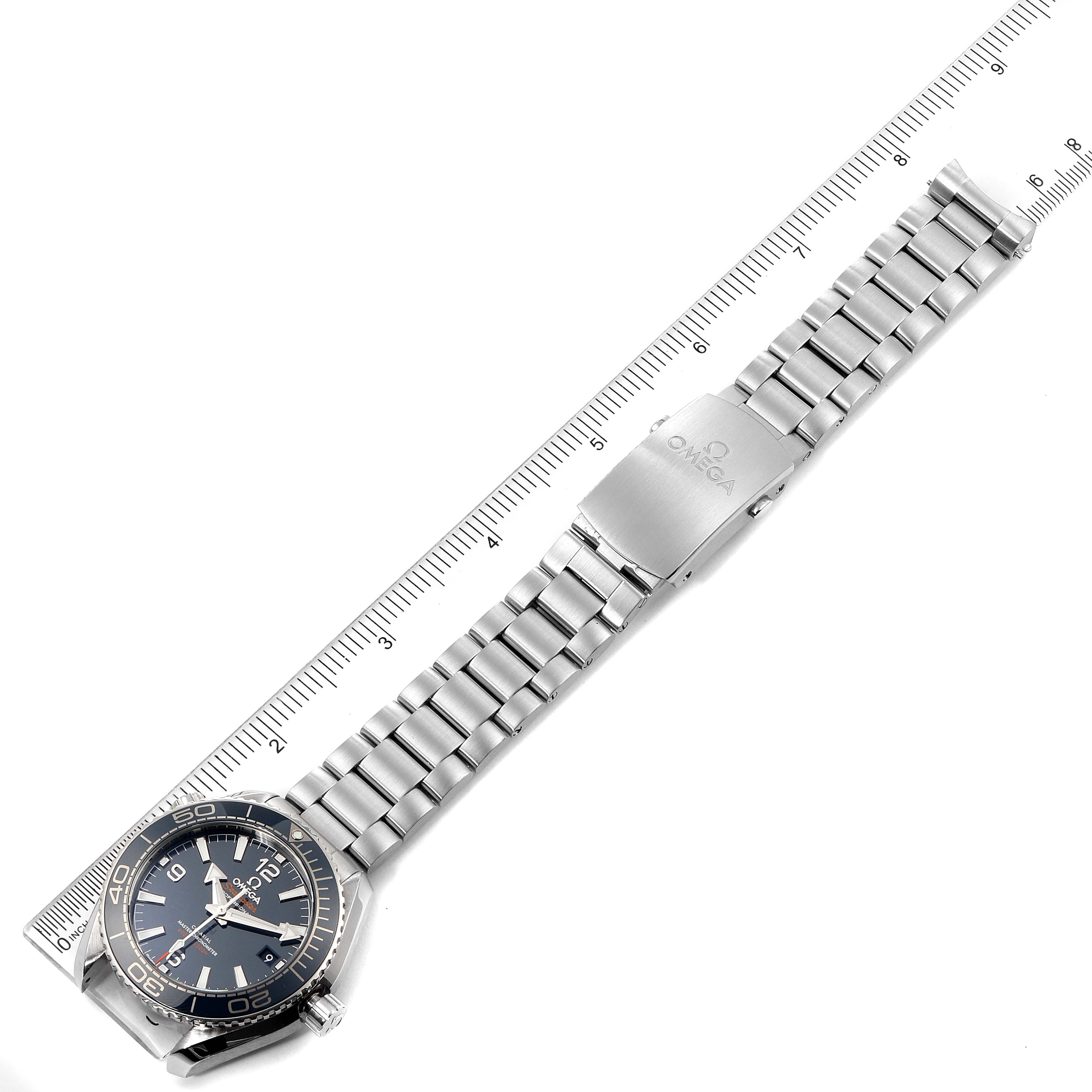 The image shows an Omega Planet Ocean 215.30.40.20.03.001 Men
s Stainless Steel Blue Dial 215.30.40.20.03.001 Men
s Stainless Steel Blue Dial watch laid flat with its stainless steel bracelet fully extended alongside a ruler.