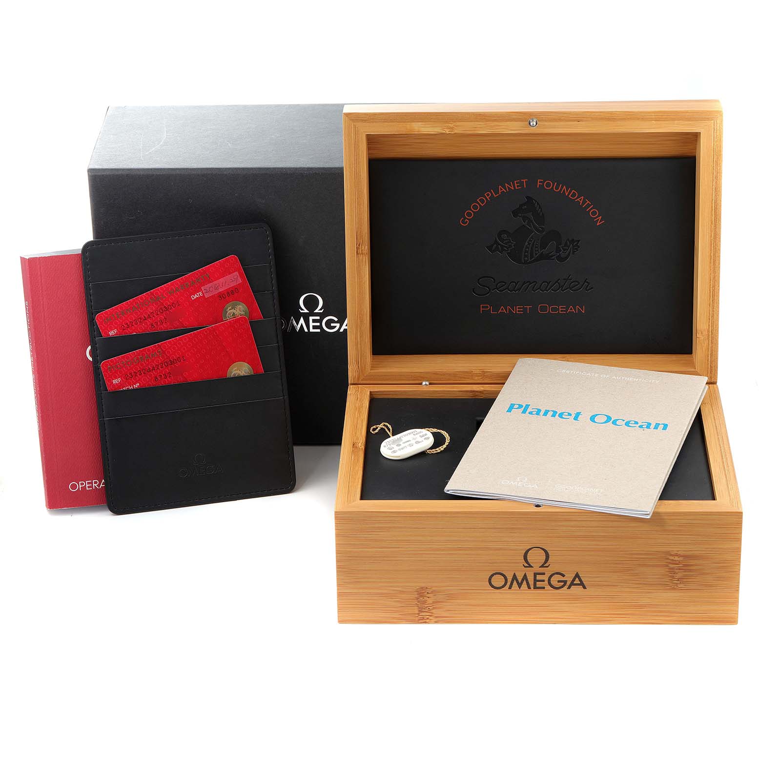The image shows a Planet Ocean by Omega box set, including the wooden box, manuals, warranty cards, and a case.