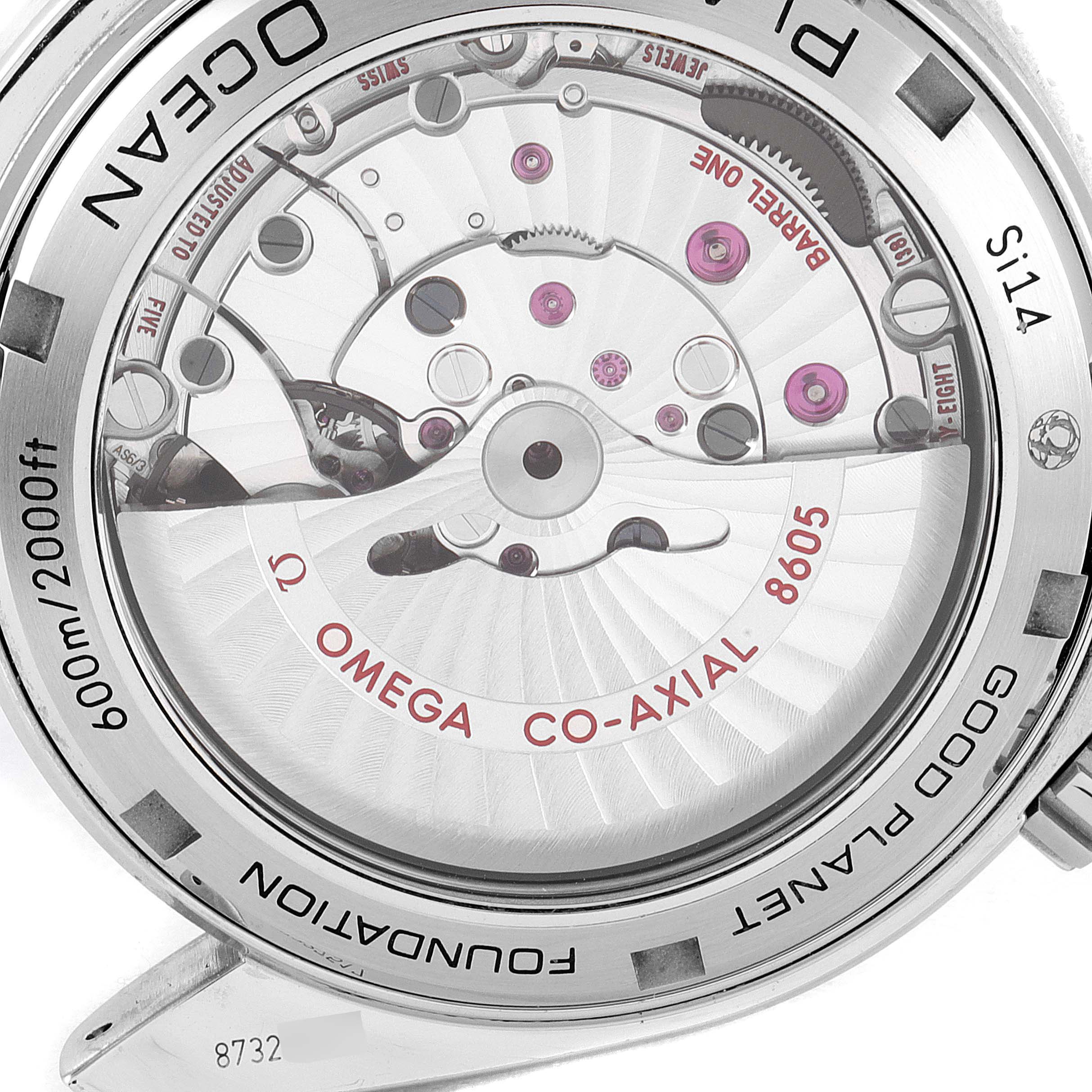 The image shows the back of an Omega Planet Ocean 232.30.44.22.03.001 Men's Stainless Steel Blue Dial 232.30.44.22.03.001 Men's Stainless Steel Blue Dial watch, revealing the mechanical movement and Co-Axial escapement.