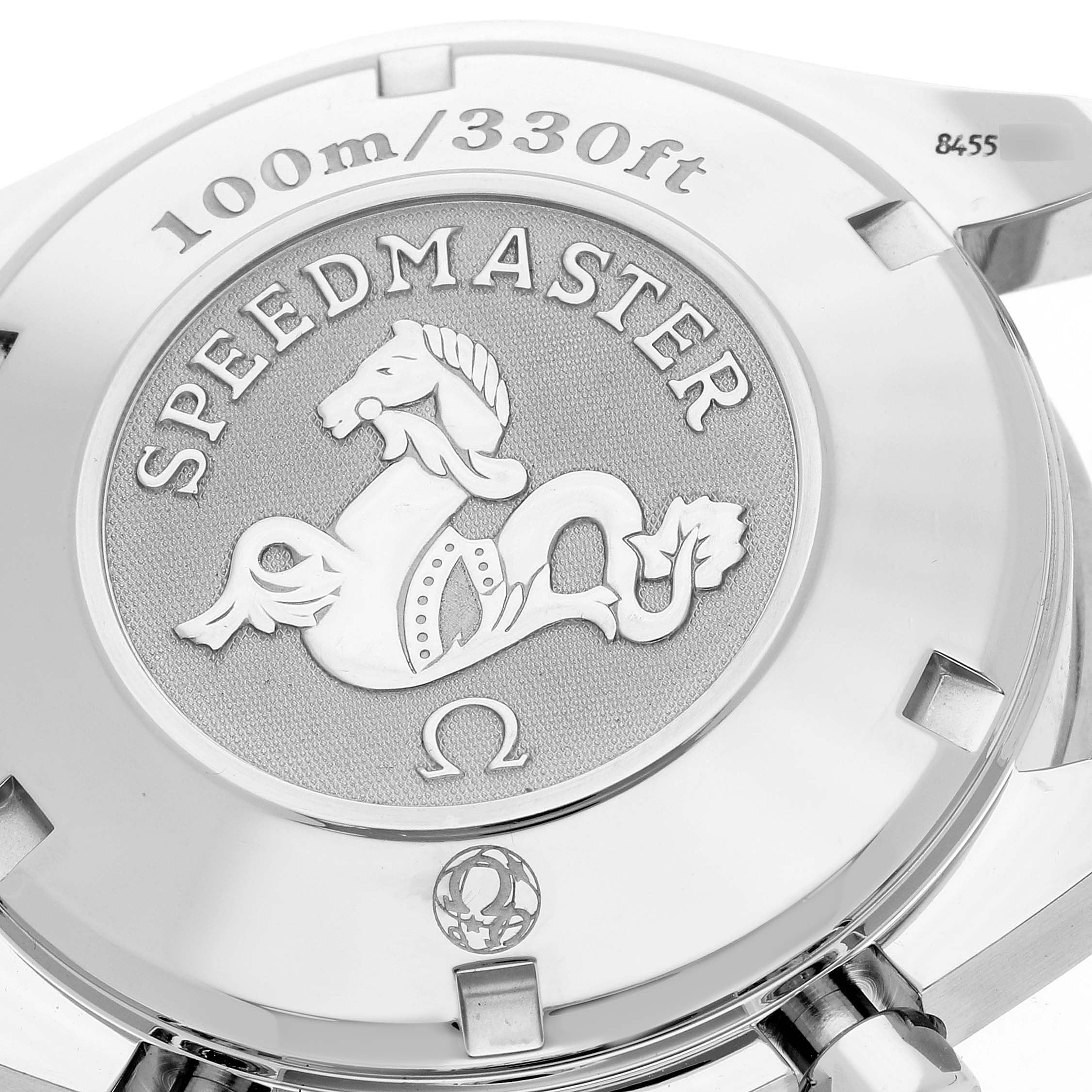 The image shows the back case of an Omega Speedmaster 3211.32.00 Men
s Stainless Steel Silver Dial 3211.32.00 Men
s Stainless Steel Silver Dial watch, highlighting the emblem and water resistance rating.