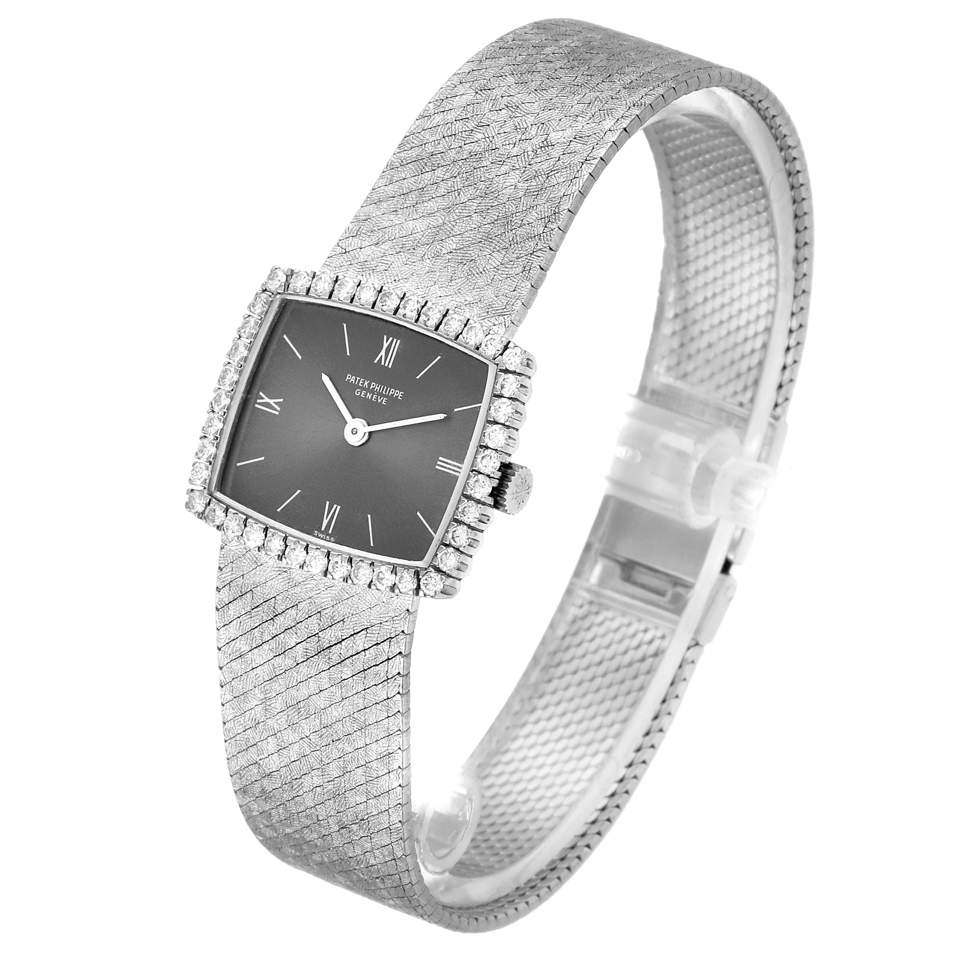 The image shows a side view of the Patek Philippe 3353/1 Women
s White Gold Grey Dial 3353/1 Women
s White Gold Grey Dial 3353 model, highlighting its 18k white gold case and diamond bezel.