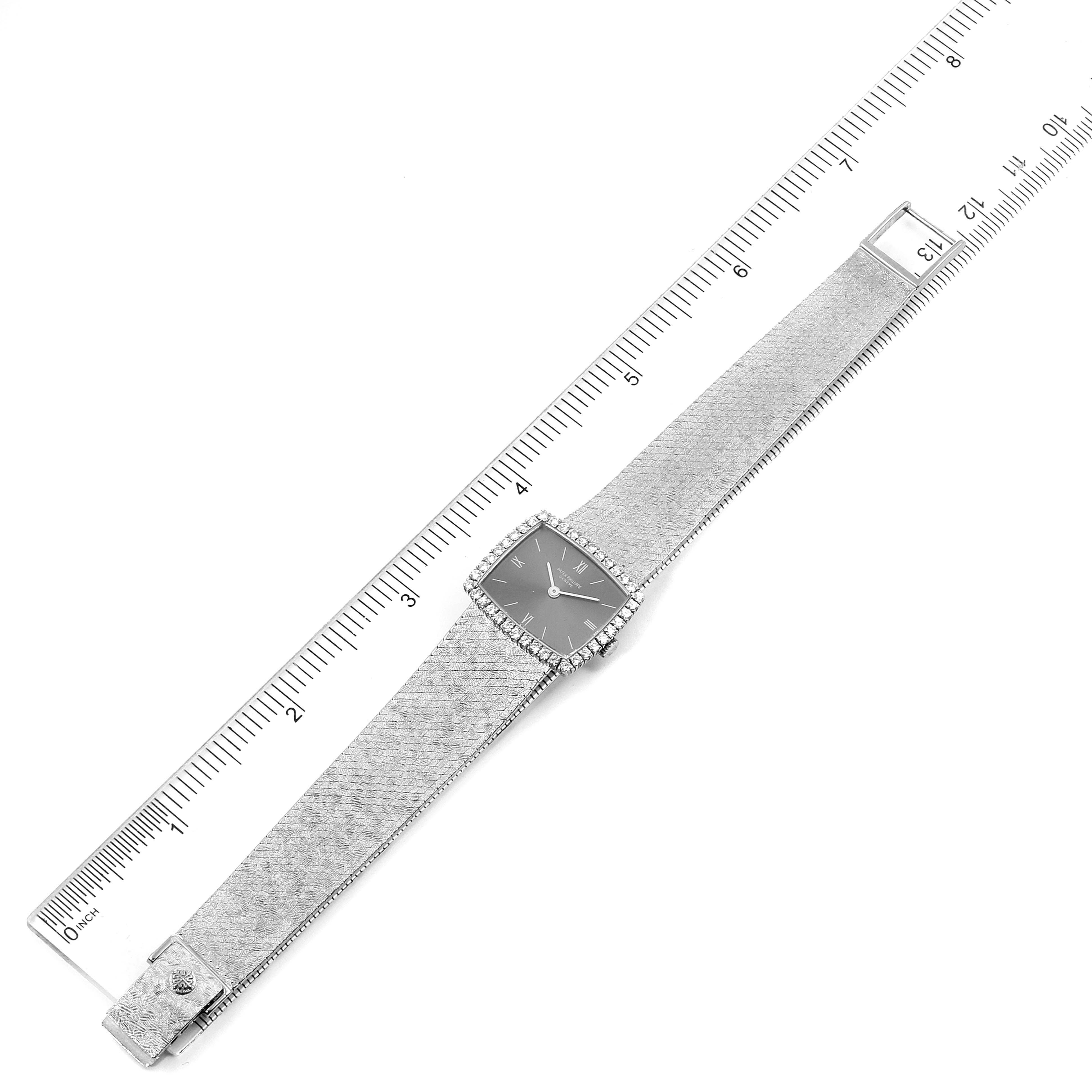 The Patek Philippe 3353/1 Women
s White Gold Grey Dial 3353/1 Women
s White Gold Grey Dial 3353 ladies watch is shown from a top-down angle, featuring its 18k white gold diamond bezel and full bracelet.