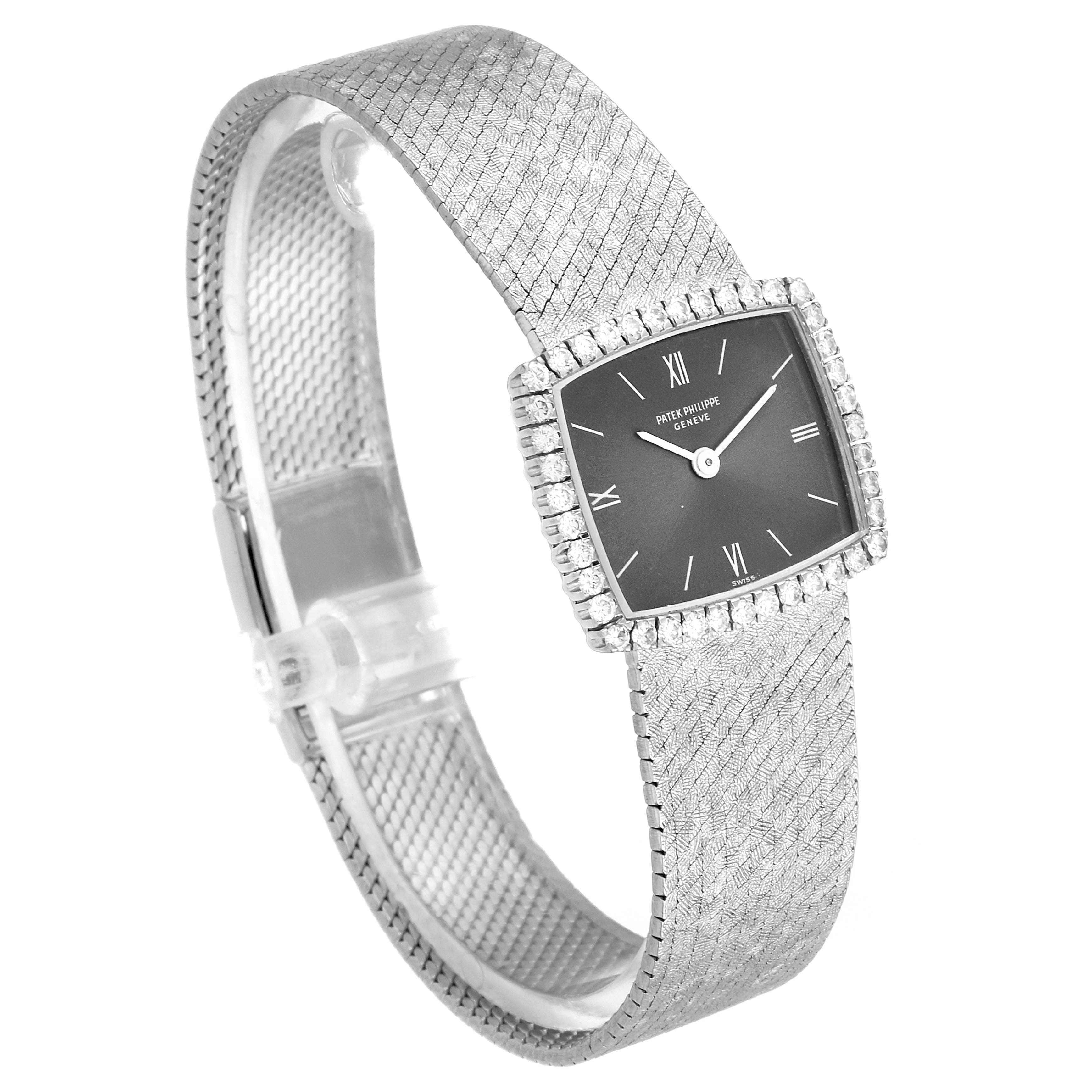 The image shows a Patek Philippe 3353/1 Women
s White Gold Grey Dial 3353/1 Women
s White Gold Grey Dial 3353 model from an angled top view, highlighting the dial, diamond bezel, and bracelet.