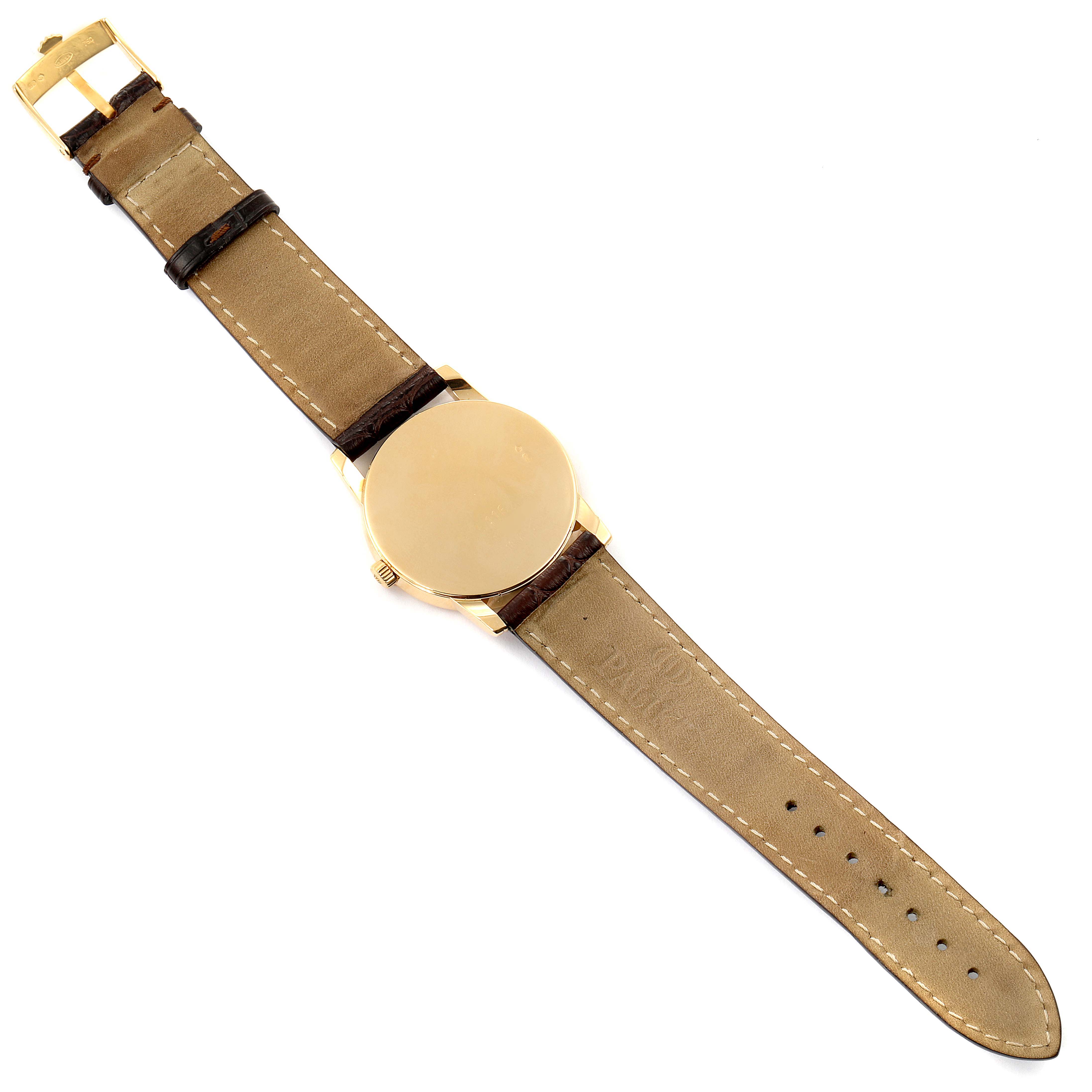 This image shows a Rolex Cellini 5116 Men's Yellow Gold Silver Dial 5116 Men's Yellow Gold Silver Dial watch from a top-down angle, highlighting its leather strap and gold case.