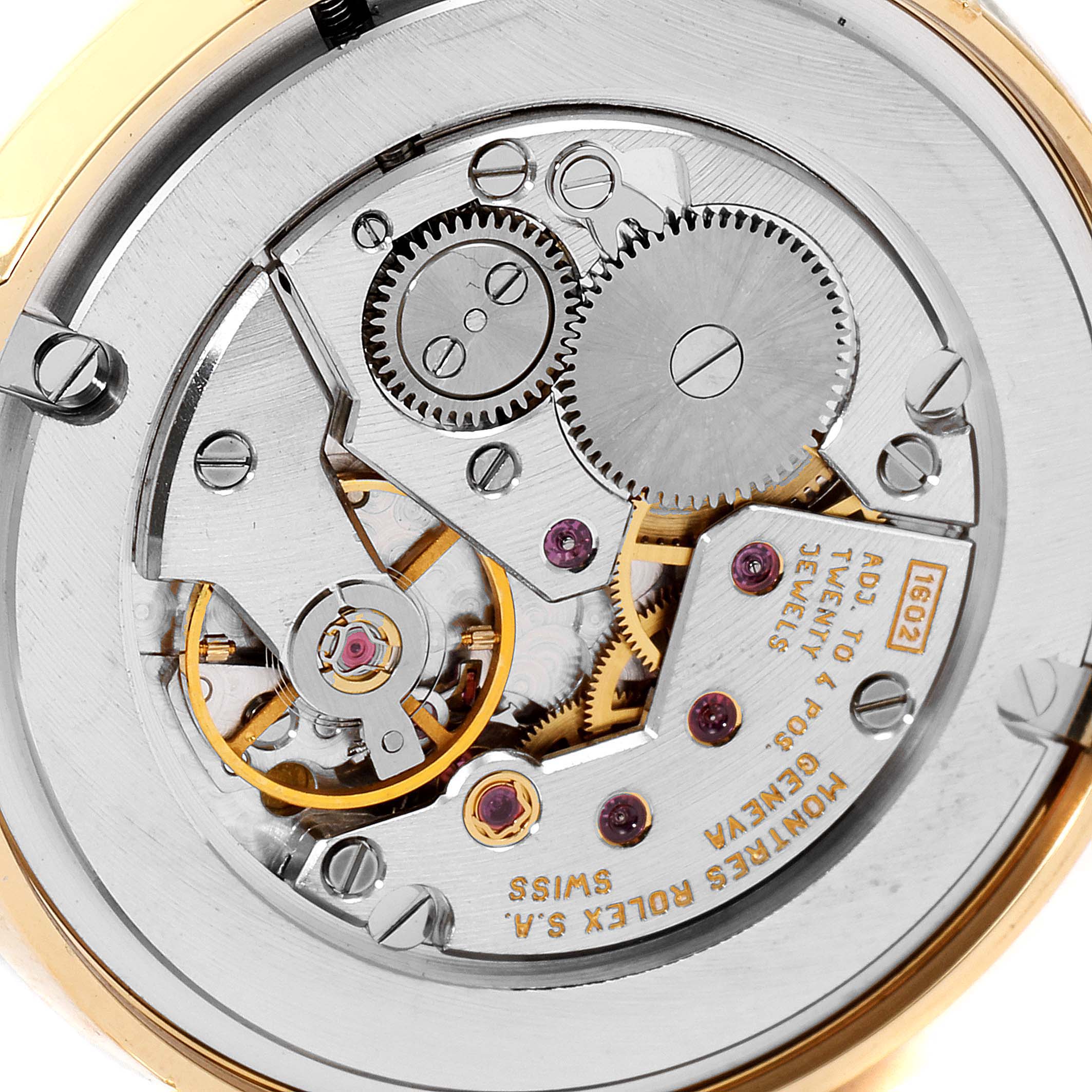 This image shows the intricate internal mechanism of a Rolex Cellini 5116 Men's Yellow Gold Silver Dial 5116 Men's Yellow Gold Silver Dial watch, focusing on its gears and movement components from a top-down angle.