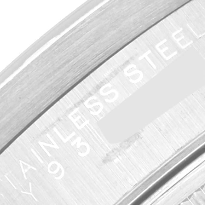 This image shows a close-up of the bezel and inner edge with "STAINLESS STEEL" engraved on a Rolex Date 15210 Men's Stainless Steel Black Dial 15210 Men's Stainless Steel Black Dial model watch.
