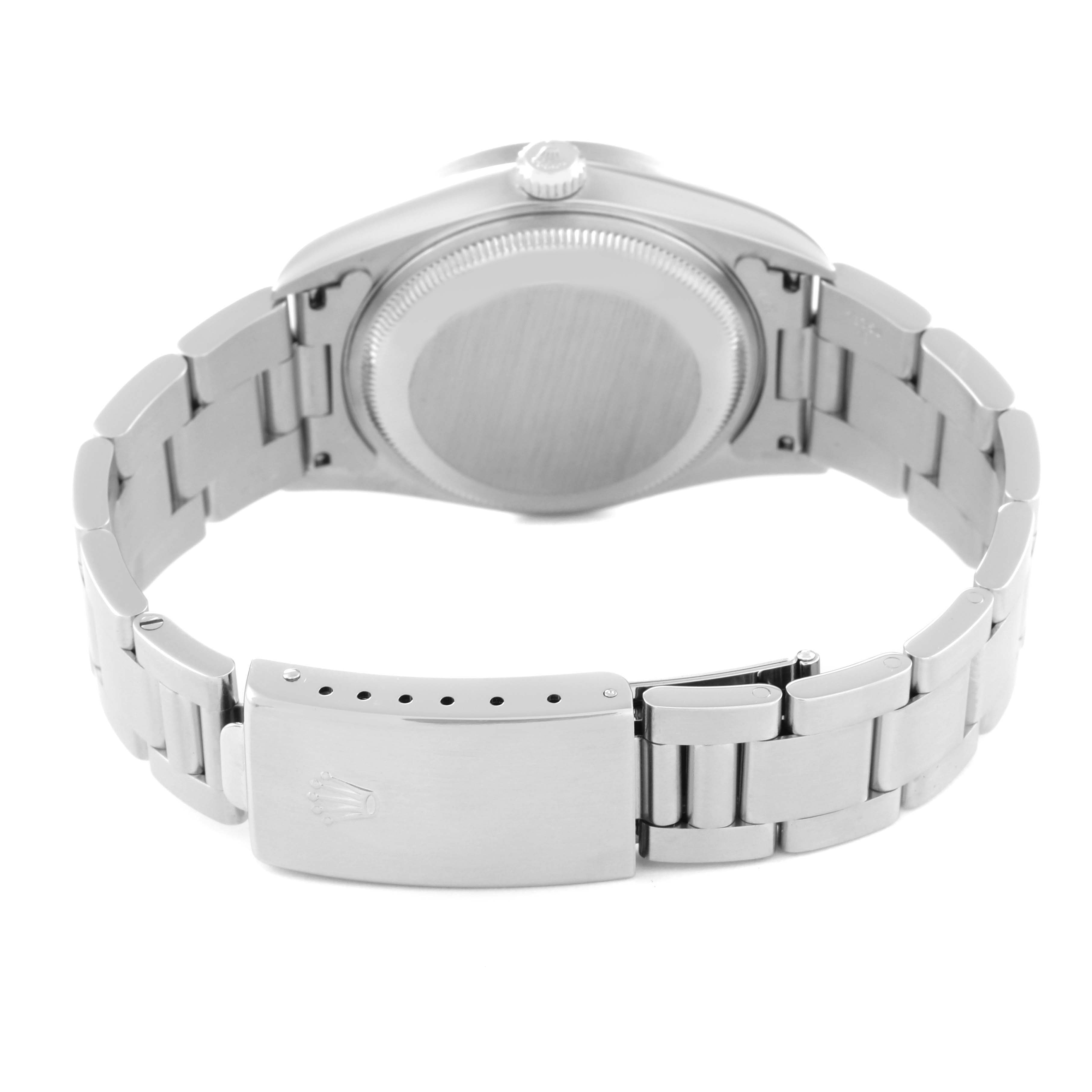 The image shows the back of a Rolex Date 15210 Men's Stainless Steel Black Dial 15210 Men's Stainless Steel Black Dial model watch, focusing on the case back and the closed metal bracelet clasp.