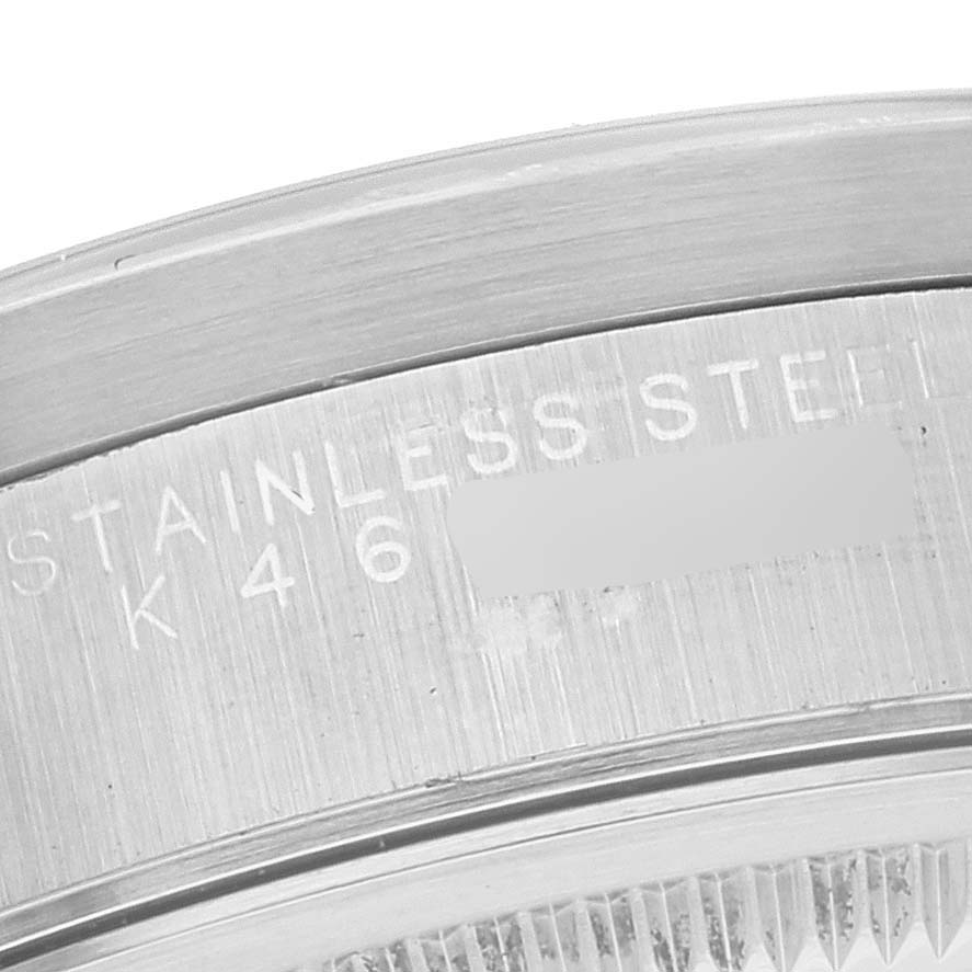 This close-up image of a Rolex Date 15210 Men's Stainless Steel Blue Dial 15210 Men's Stainless Steel Blue Dial model watch shows the engraved details on the stainless steel case back.