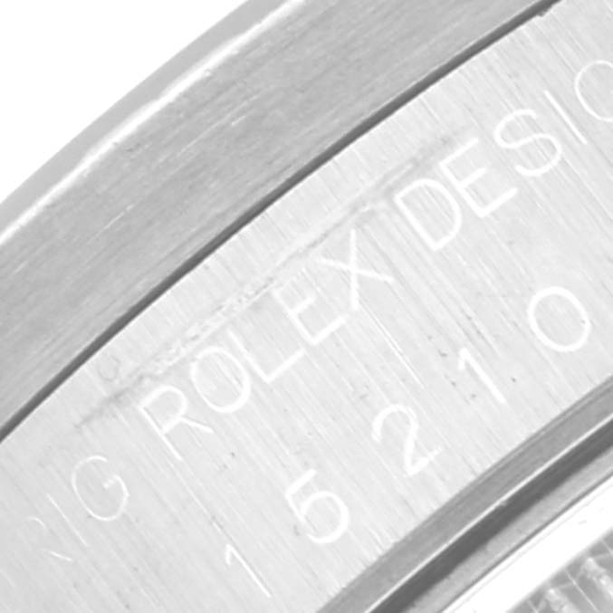 This image shows a close-up of the engraved part of the case back of a Rolex Date 15210 Men's Stainless Steel Grey Dial 15210 Men's Stainless Steel Grey Dial model watch.