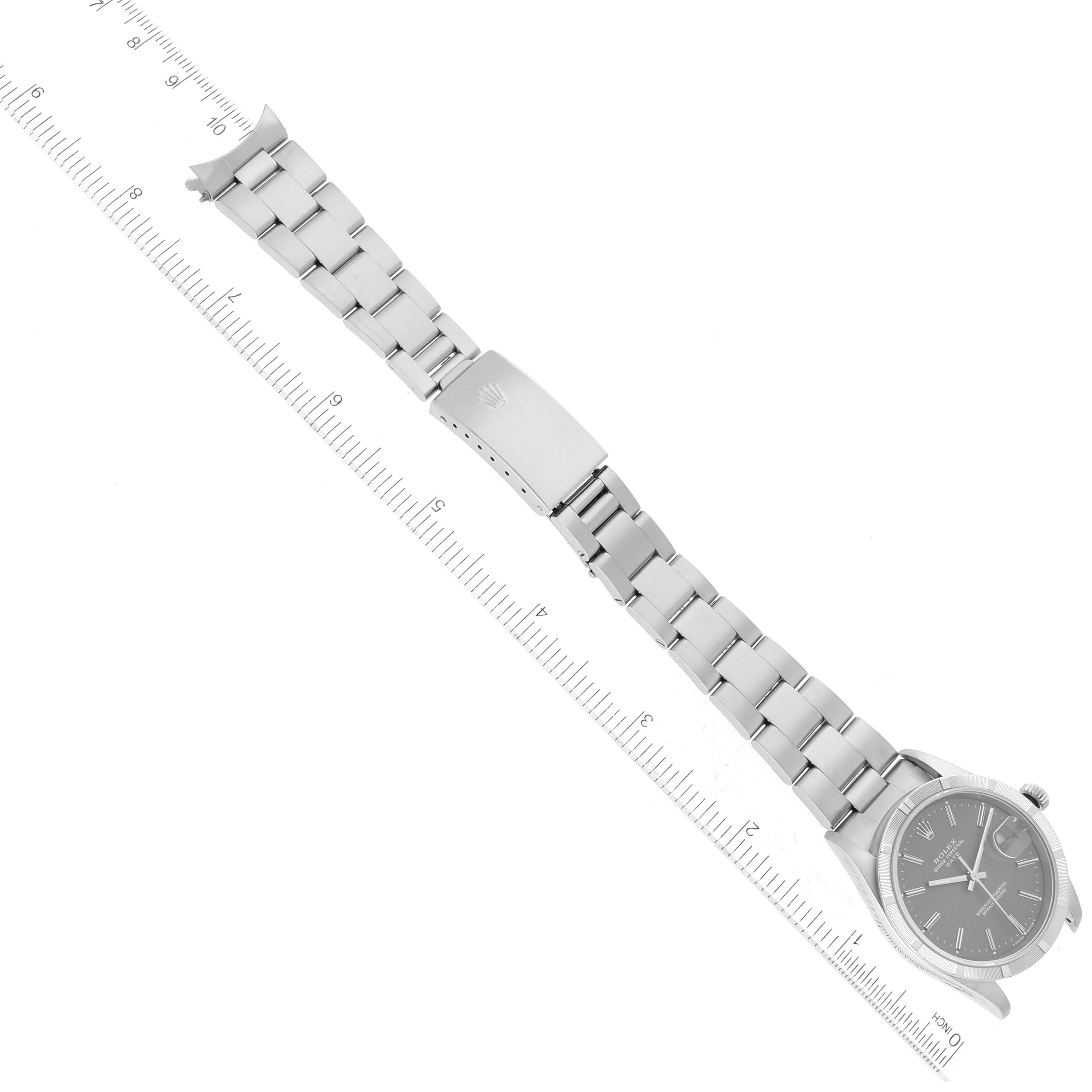 This image shows a top-down angle of a Rolex Date 15210 Men's Stainless Steel Grey Dial 15210 Men's Stainless Steel Grey Dial model watch, including its face, bracelet, and a ruler for scale.
