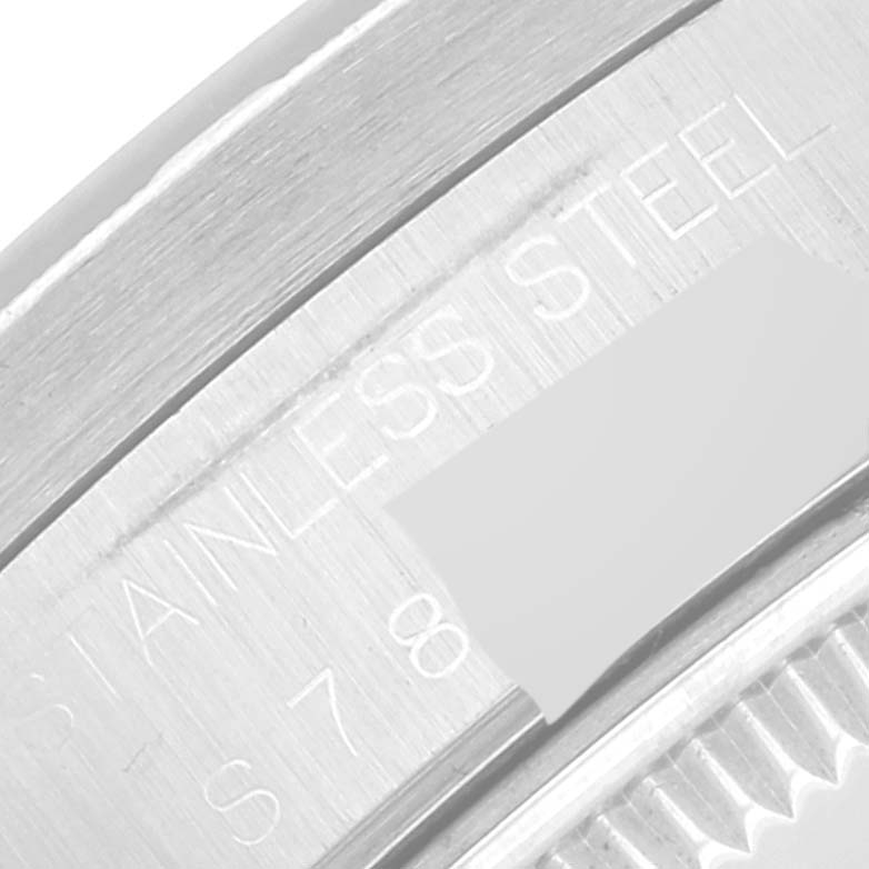 The image shows a close-up of the case back engraving on a Rolex Date 15210 Men's Stainless Steel Grey Dial 15210 Men's Stainless Steel Grey Dial model watch, specifically focusing on the stainless steel marking.