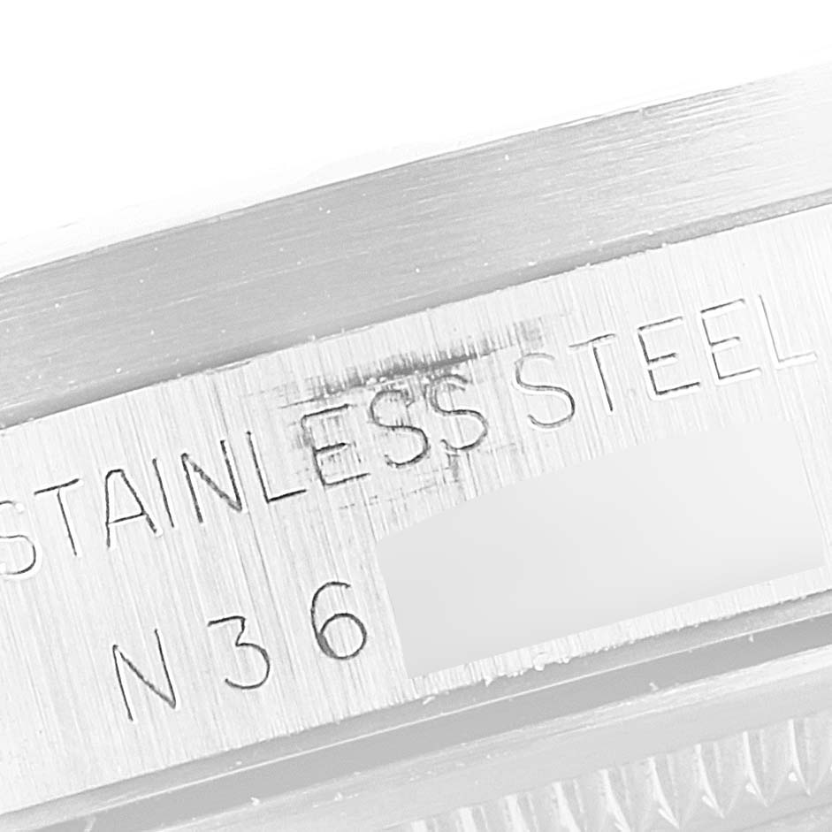 This image shows an engraved edge of the case back of a Rolex Date 15210 Men's Stainless Steel White Dial 15210 Men's Stainless Steel White Dial model watch made from stainless steel.