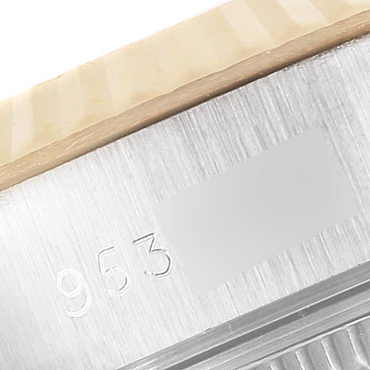 The image shows a close-up of the fluted bezel and a part of the case with serial numbers on a Rolex Datejust 69173 Women
s Steel and Gold (two tone) Champagne Dial 69173 Women
s Steel and Gold (two tone) Champagne Dial watch.