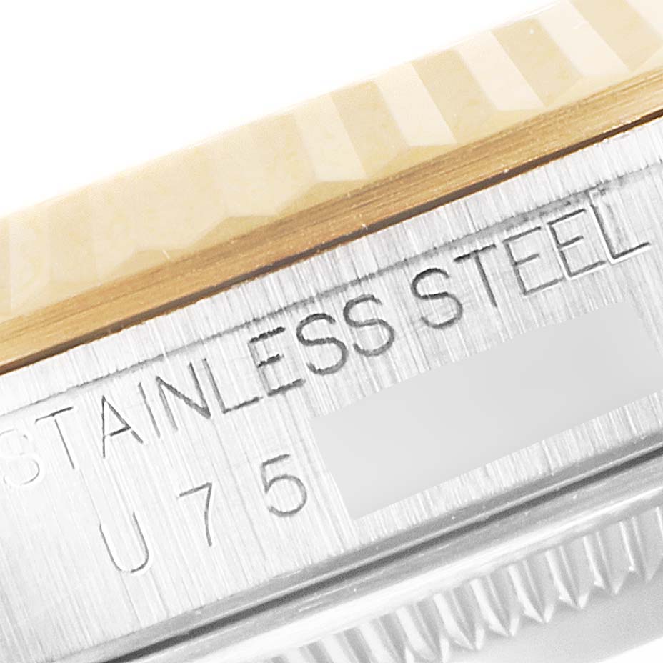 The image shows a close-up of the side of a Rolex Datejust 16233 Men's Steel and Gold (two tone) Champagne Dial 16233 Men's Steel and Gold (two tone) Champagne Dial, highlighting the stainless steel engraving and part of the bezel.